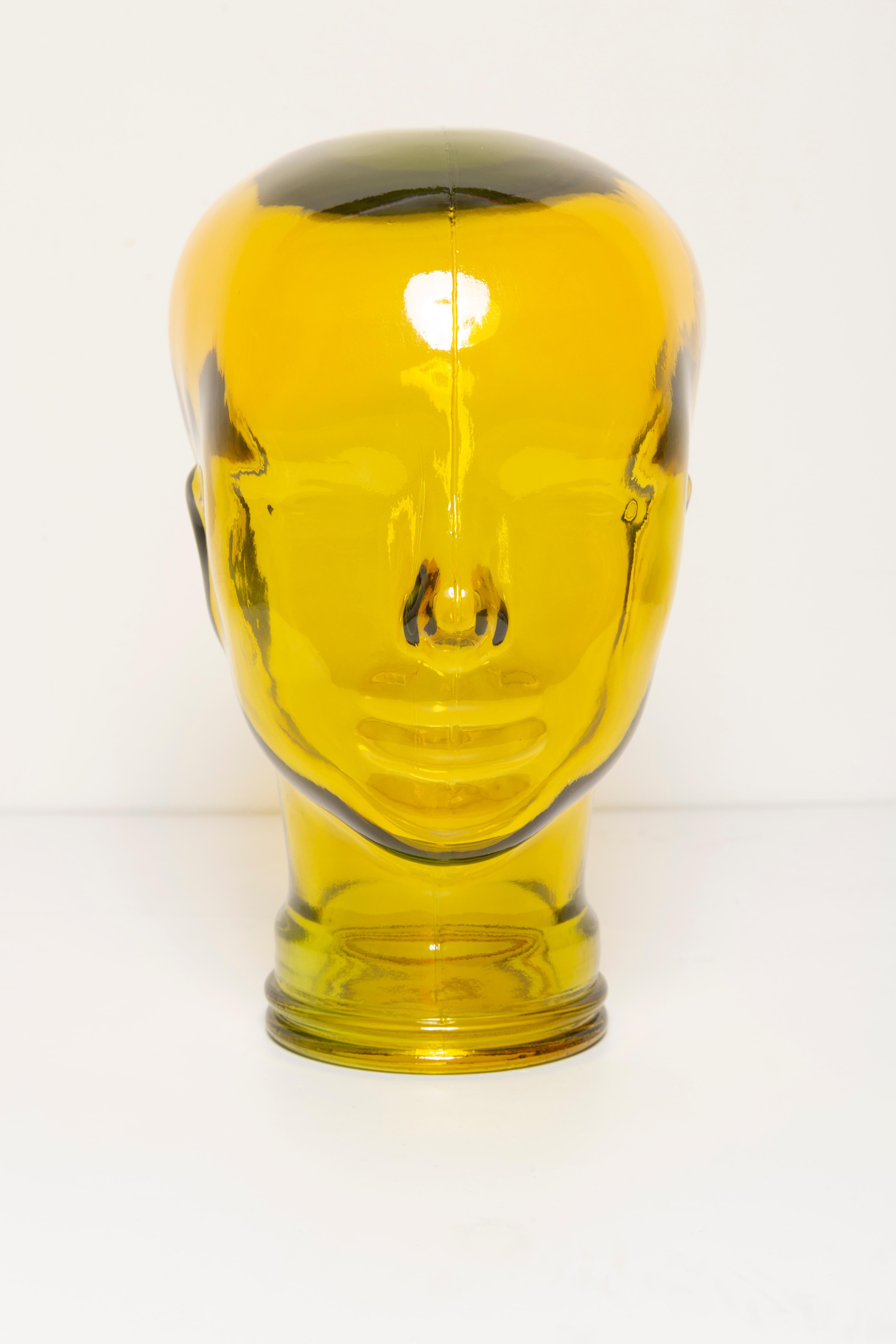 Life-size glass head in a unique yellow color. Produced in a German steelworks in the 1970s. Perfect condition. A perfect addition to the interior, photo prop, display or headphone stand.