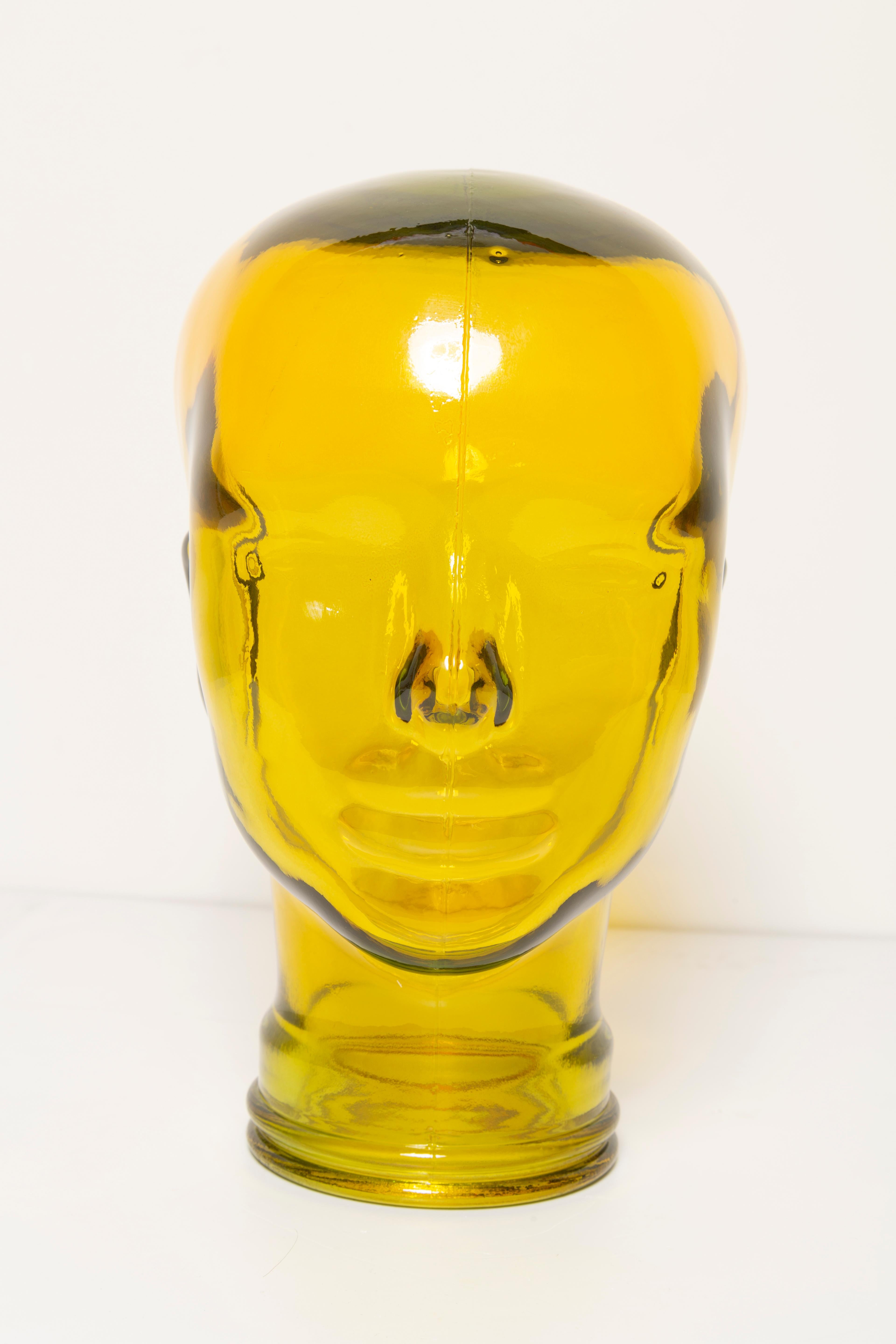 Life-size glass head in a unique yellow color. Produced in a German steelworks in the 1970s. Perfect condition. A perfect addition to the interior, photo prop, display or headphone stand.