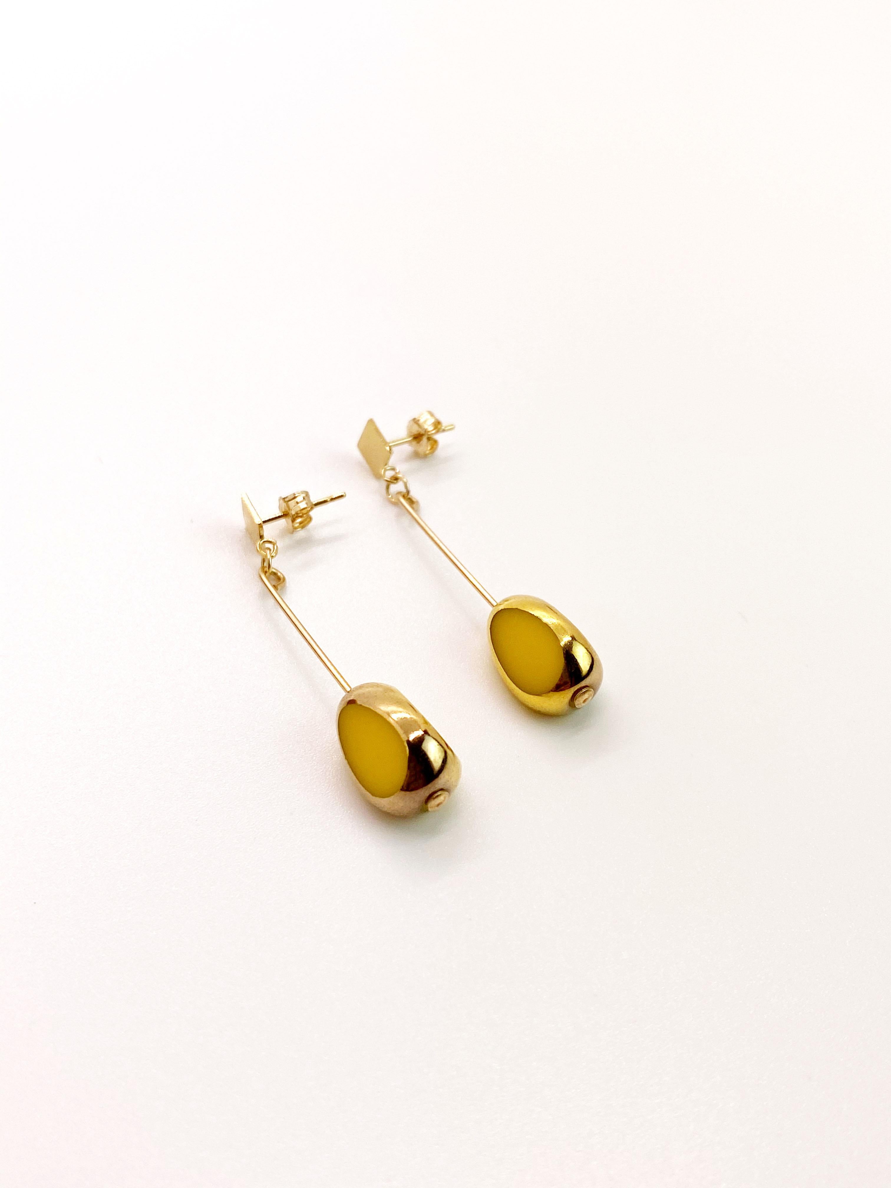 Yellow vintage German glass beads edged with 24K gold dangles on a 14K gold filled ear wire. 

The German vintage glass beads are considered rare and collectible, circa 1920s-1960s.

*Our jewelry have maximum protection for anti-tarnish and is made