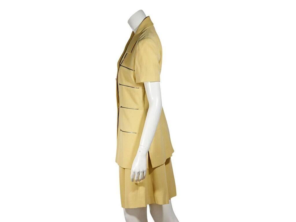 Product details:  Vintage yellow shorts suit set by Karl Lagerfeld.  Notched lapel.  Short sleeves.  Button-front closures.  Front zipper accents.  Matching culotte shorts.  High waisted.  Double button and zip closure.  Label size FR 40.  Jacket: 