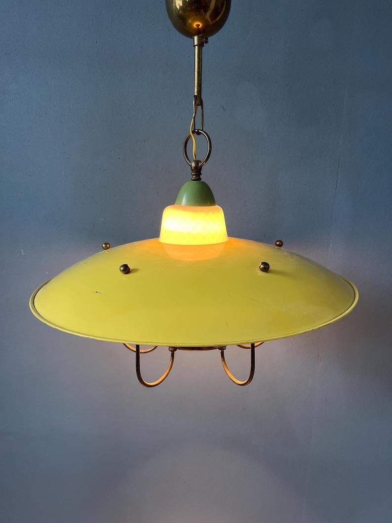 50s mid century lantern style glass pendant lamp with enamel outer shade and opaline glass inner shade. The piece beautifully combines white with soft yellow and green colours. The piece has some decorative brass elements, holding the milk glass