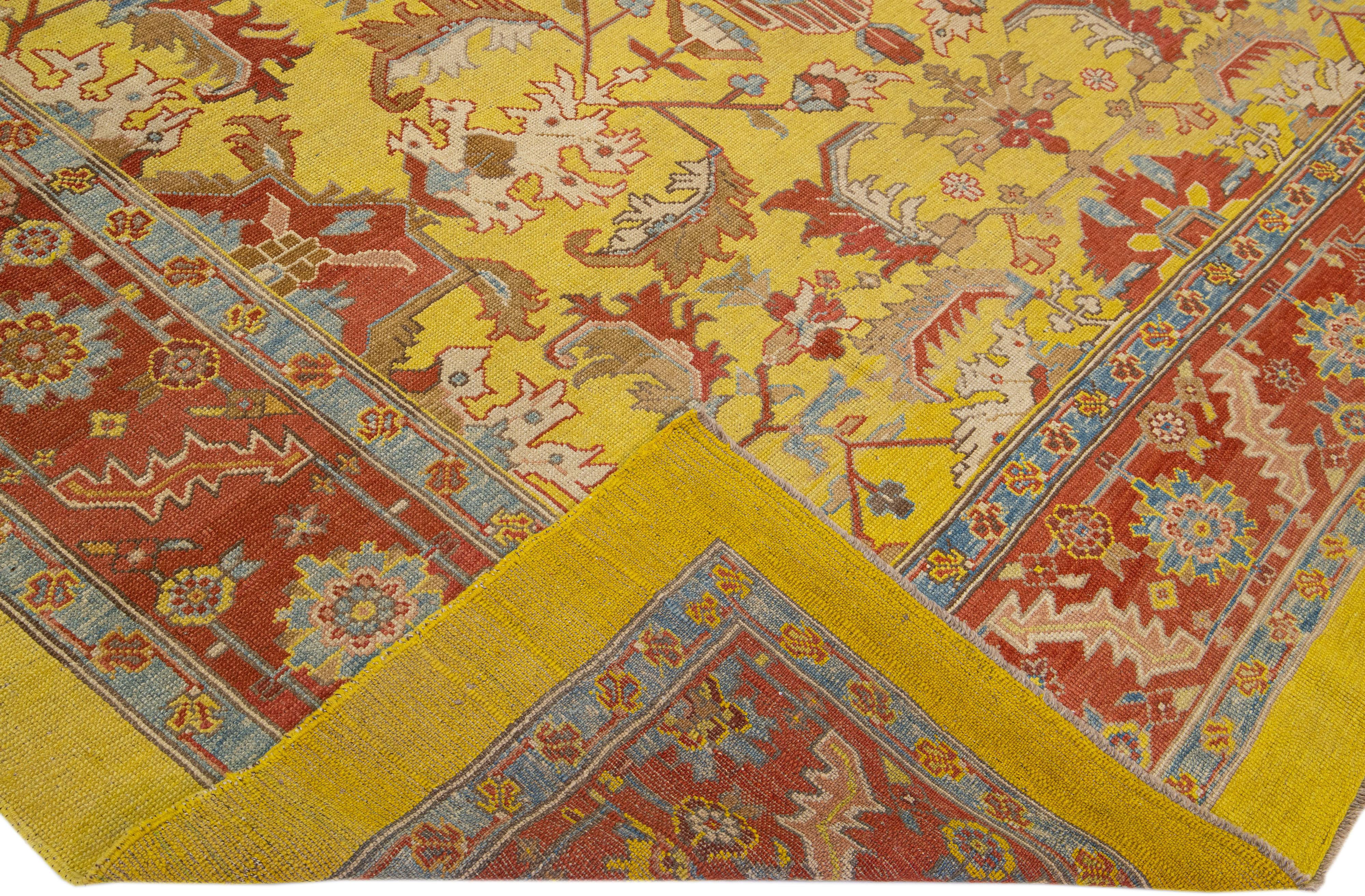 Beautiful vintage Bakshaish hand-knotted wool rug with a yellow field. This rug has a red- rust designed frame with accents of blue and brown in an all-over geometric tribal design.

This rug measures 10' 6