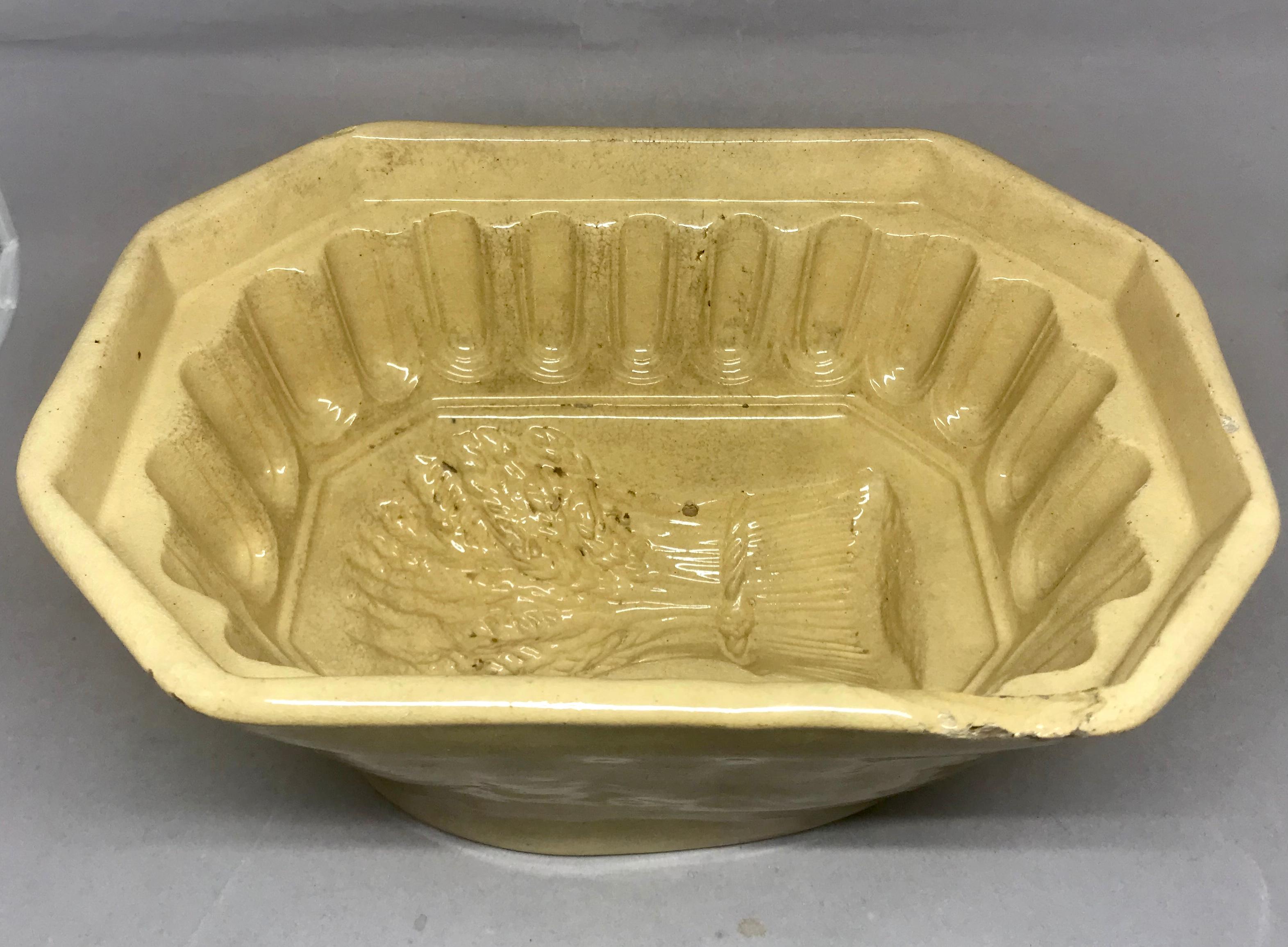 Yellow ware wheat sheaves jelly pudding mould. Antique glazed yellow ware pottery jelly/pudding mould with fluted inset rim and wheat sheaf design from New Jersey or Pennsylvania. Two small old losses to mould as seen in photos, United States, circa