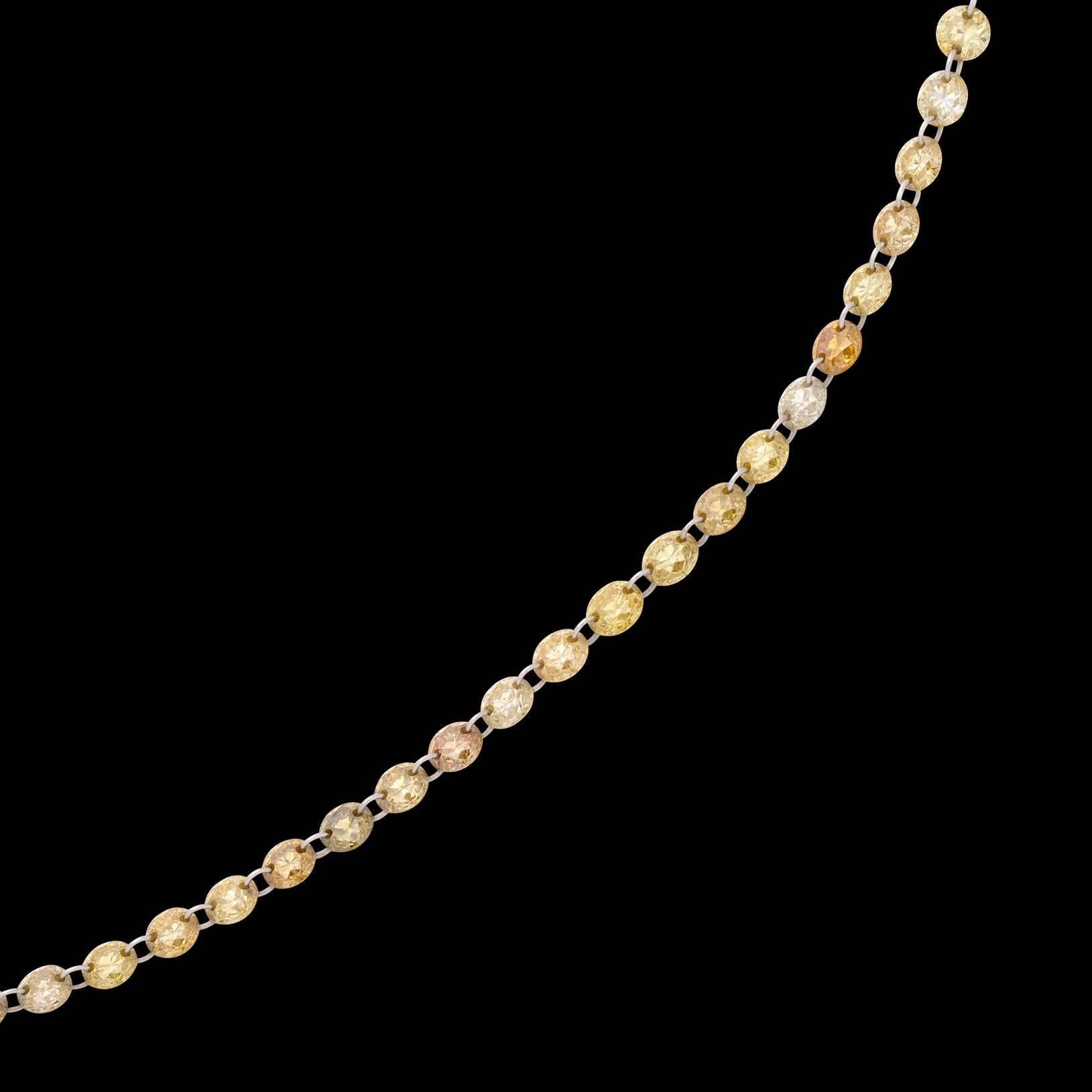 For the lover of the finer things! This beautiful necklace features 7.44 carats of fine Yellow, White and Champagne colored natural diamonds delivering an eye catching look with a variety of rare stones. The round cut diamonds have been expertly set