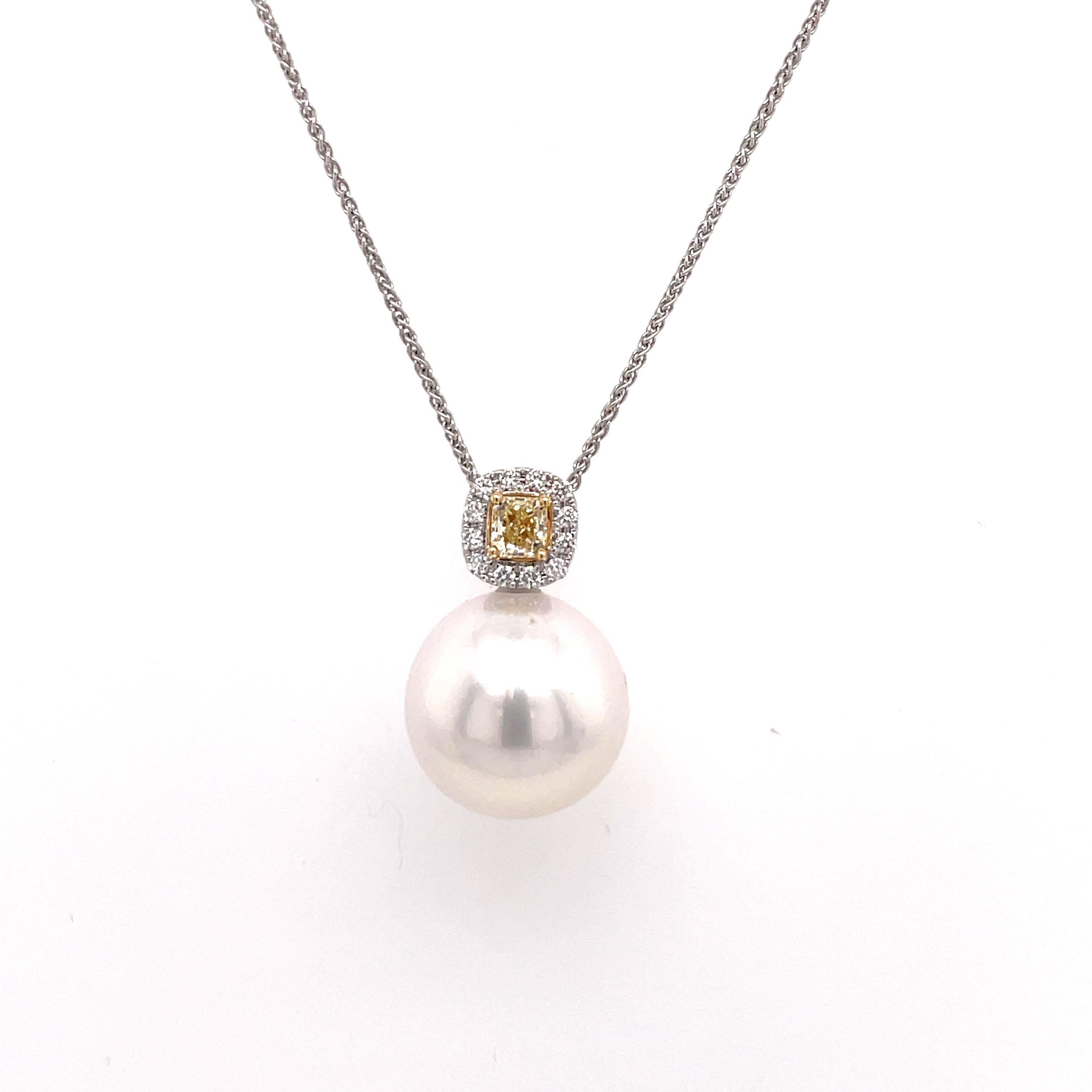 18 Karat White Gold pendant featuring one South Sea Pearl measuring 14-15 mm with a Radiant cut yellow diamond weighing 0.25 carats flanked with round brilliants weighing 0.12 carats.
Color G-H
Clarity SI 