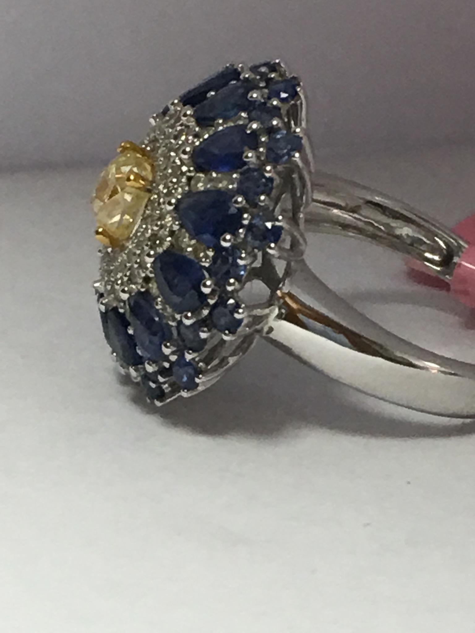Natural fancy yellow diamonds . Blue sapphire and white diamonds set  in 14K two tone gold.
Total diamonds and sapphire weight is 4.69 Carat. Size of the ring is 7 and can be resized if needed.