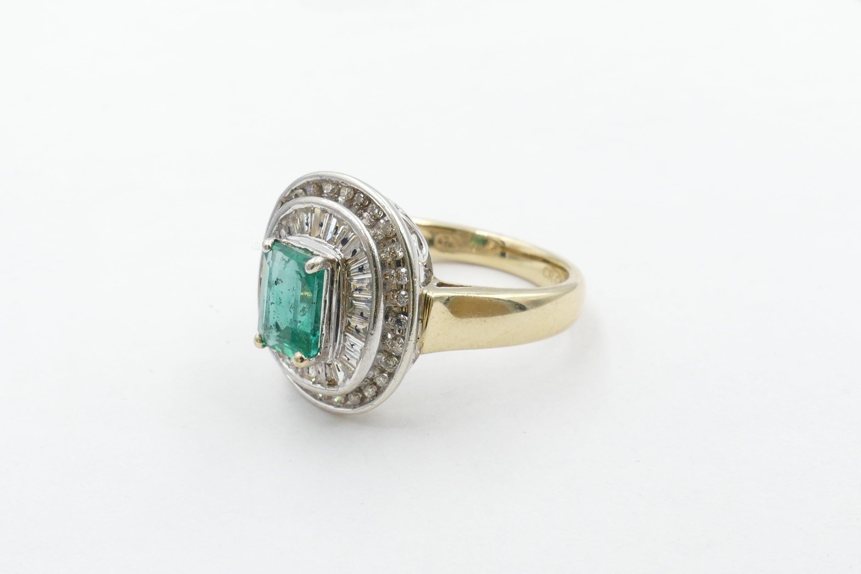 The beautiful colour Emerald centering this Ring is close to 1 carat, bluish-green in Colour, medium Tone, Emerald cut, , 4 claw set.
Surrounding the Stone are 26 tapered Baguette Cut Diamonds, Colour H/J, Clarity SI1-SI2 with a further 28 Round