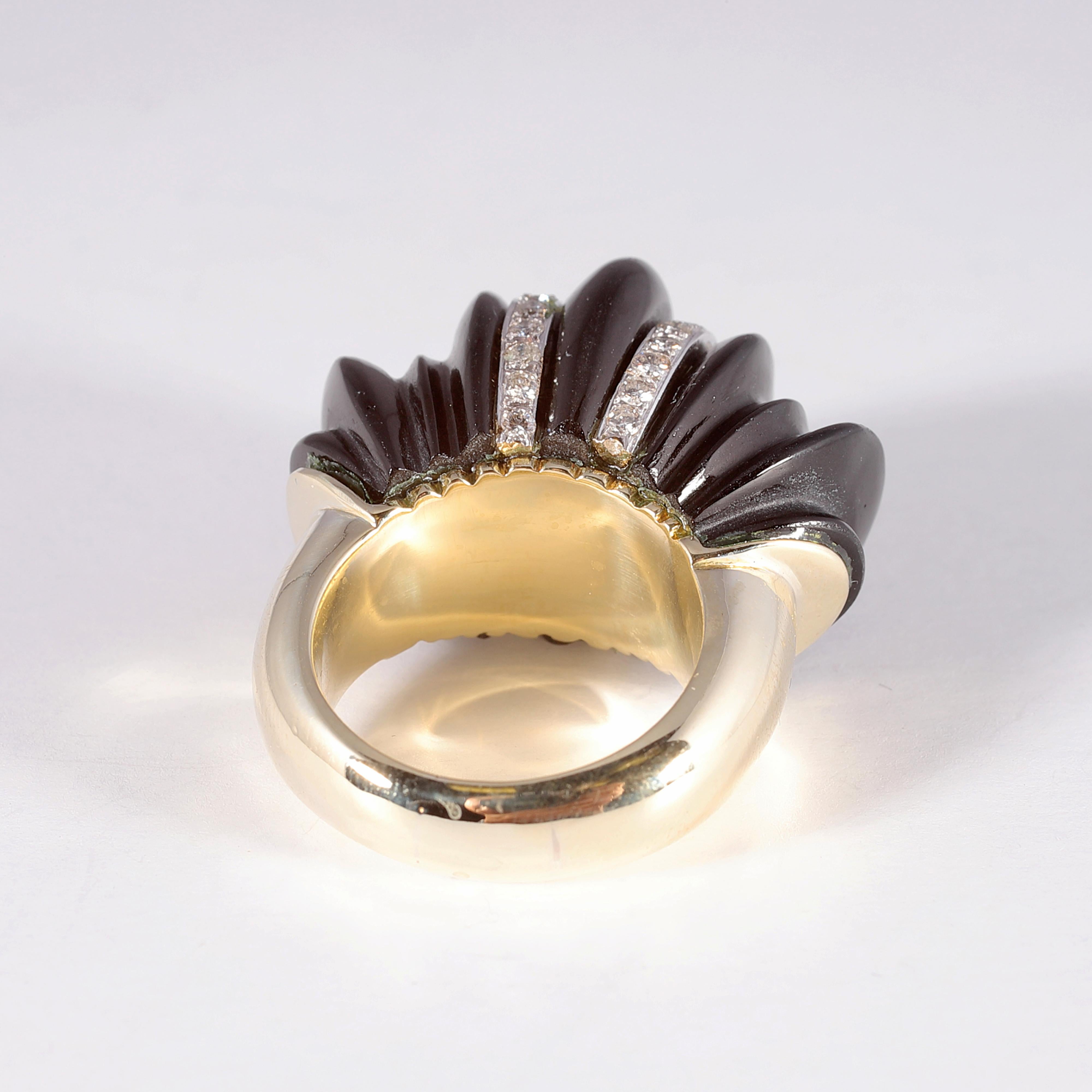 Such a stunning statement piece!  In 14 karat yellow gold, this beauty is enhanced by two rows of round bead-set, diamonds across the fluted black glass.  Size 6 1/2.