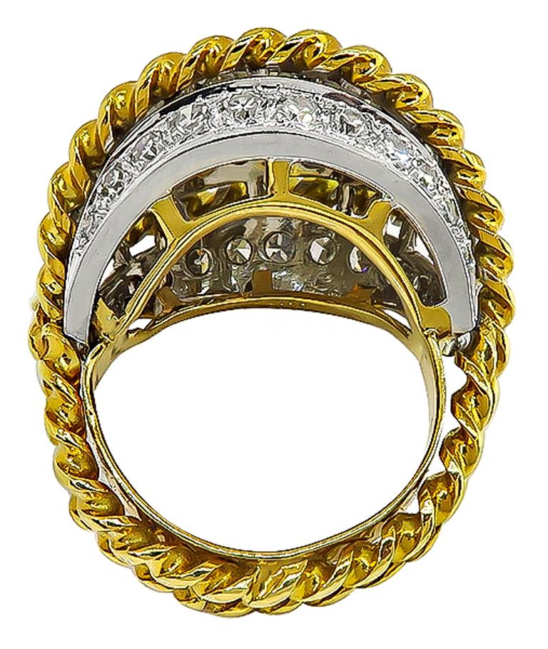 This amazing 18k yellow and white gold cocktail ring is set with sparkling round cut diamonds that weigh approximately 5.50ct. graded G color with VS1-VS2 clarity. The top of the ring measures 22mm by 27mm.
It is currently size 7 1/2, and can easily