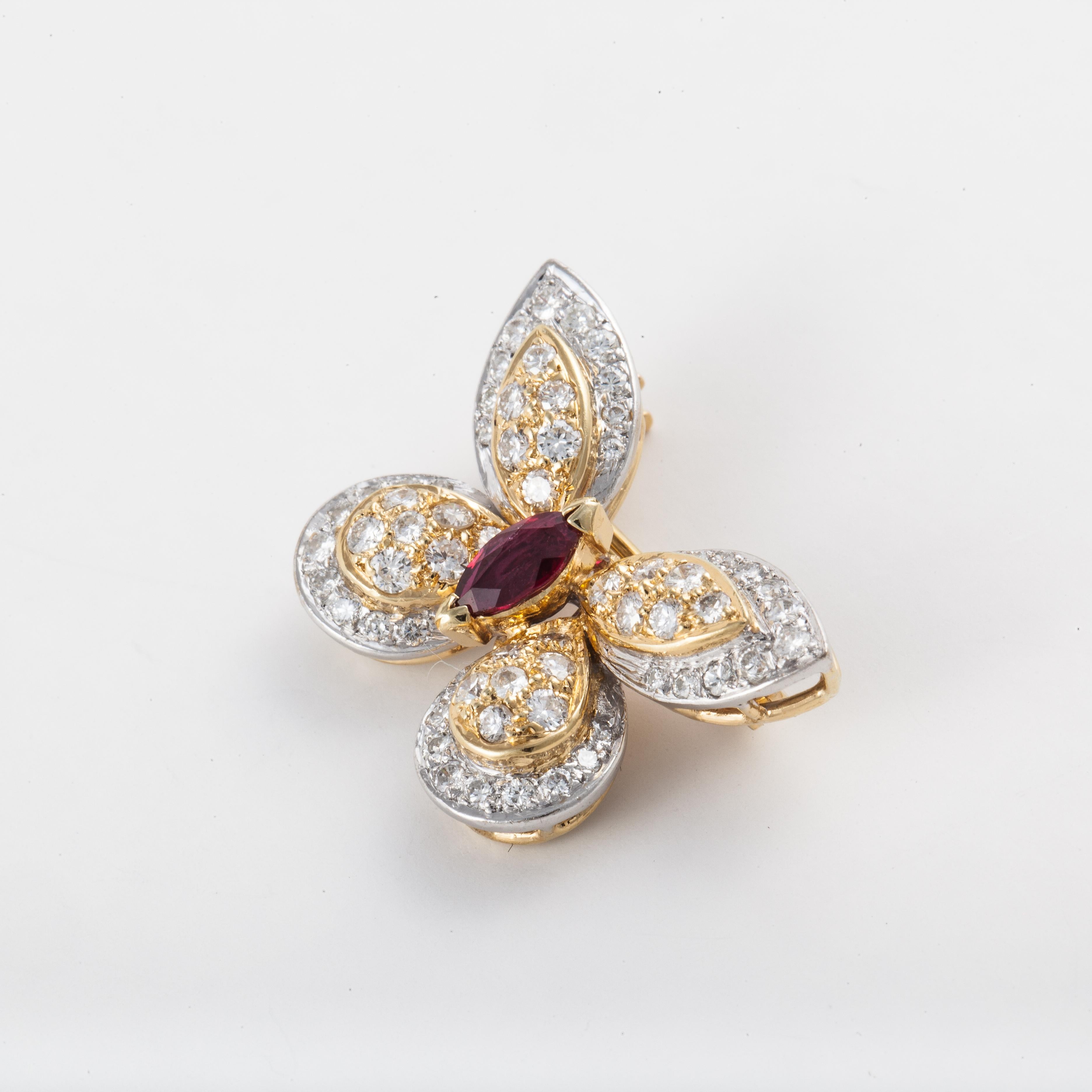 18K yellow and white gold small butterfly pin.  There are fifty (50) round diamonds totaling 1.25 carats.  The body is a marquise ruby.  Measures 7/8