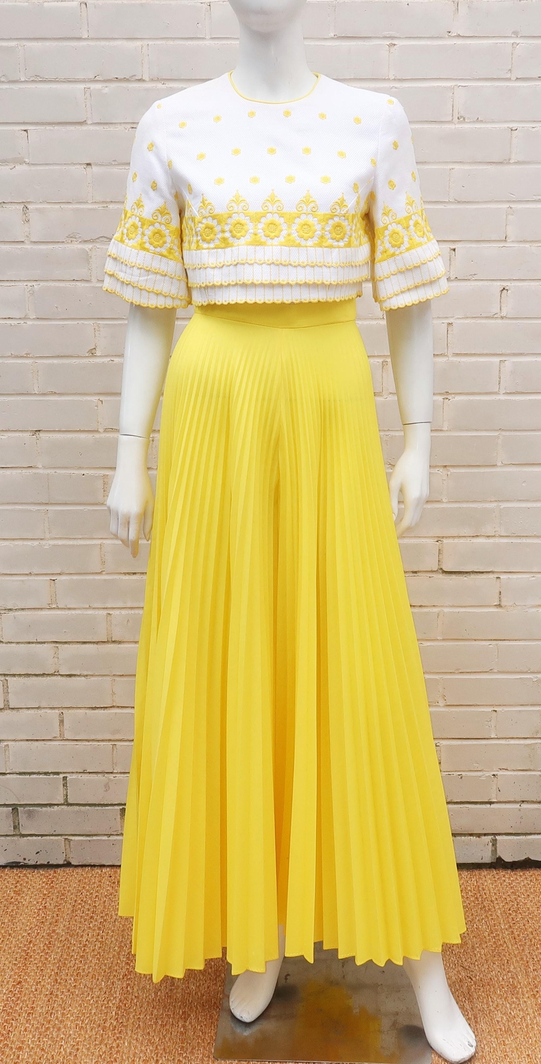 Adorable 1960's yellow and white palazzo ensemble including top and pants.  The white cotton pique cropped top buttons up the back and is decorated with yellow floral embroidery and scalloped tiers at the hem and cuffs.  The wide legged yellow