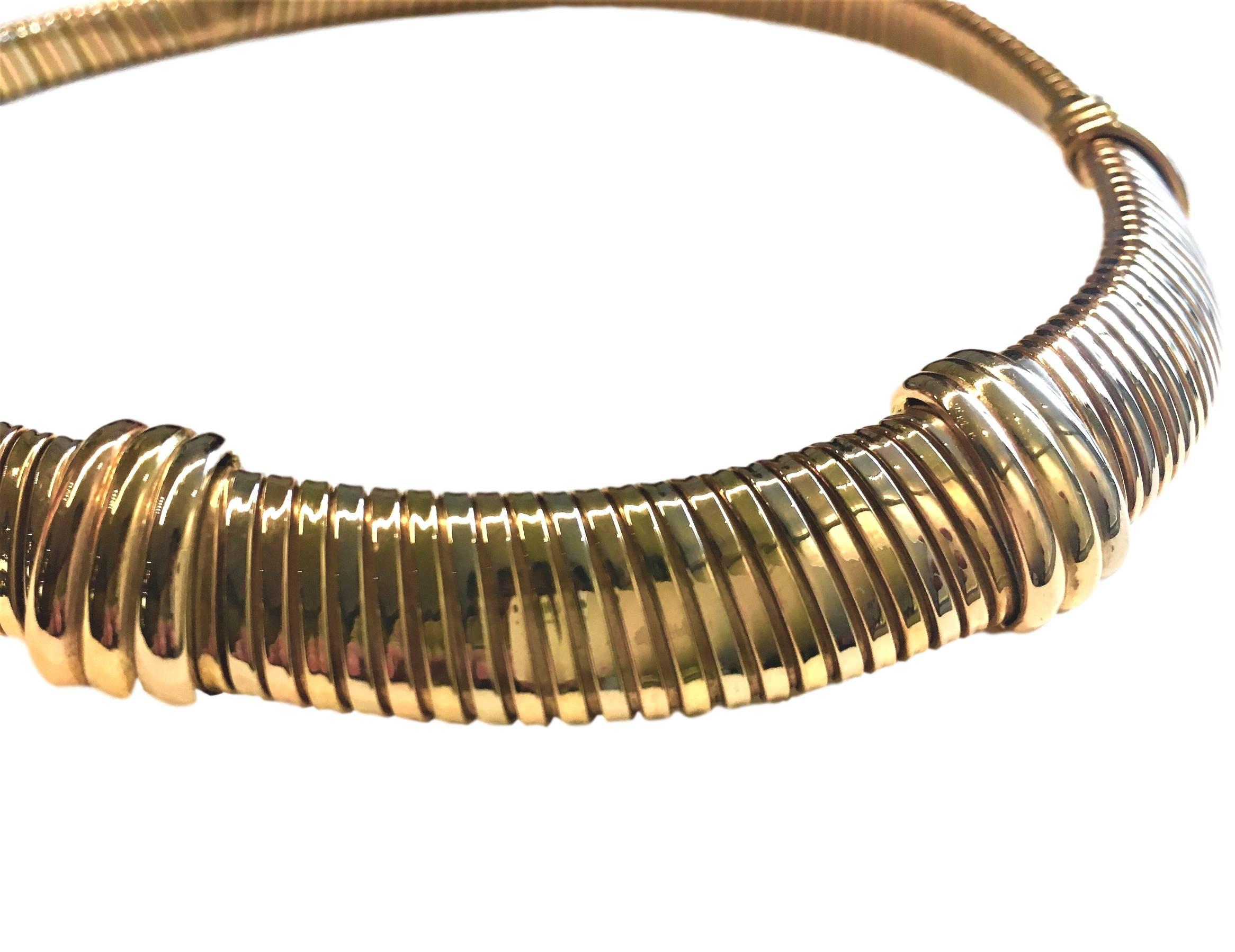Uniform row tubogas flexible choker with 3 colour trinity motifs.
Signed Cartier. Numbered.