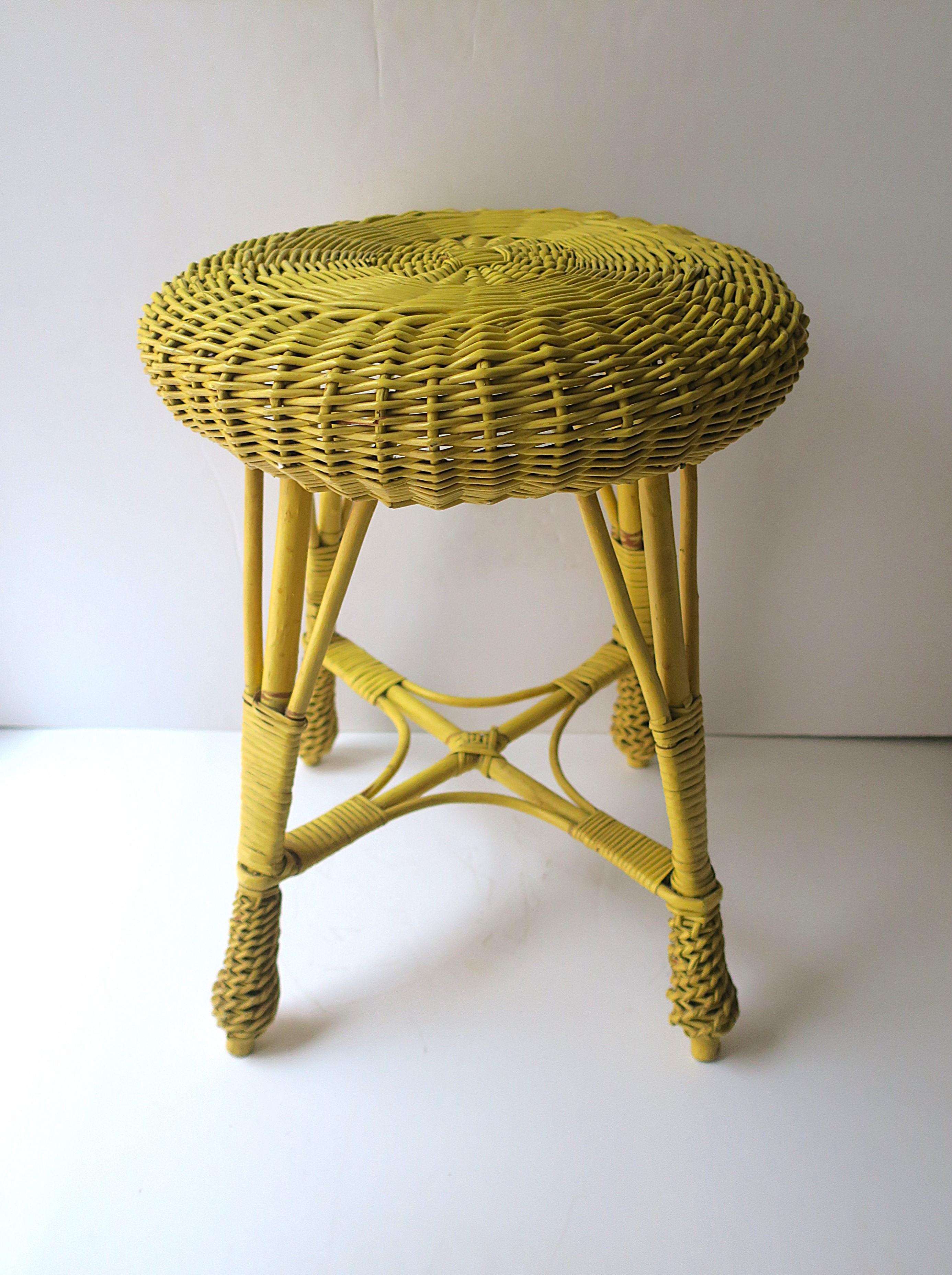 A vintage yellow wicker stool, circa mid-20th century, Yugoslavia. Great as a stool (its intended use), as a small drinks table, for a bath area, to display books, plant stand, etc. Many uses. Piece works as a drinks table providing there's a stable