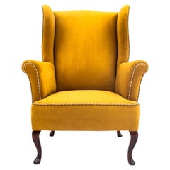 Yellow wingback armchair, Northern Europe, mid 20th century. After renovation.