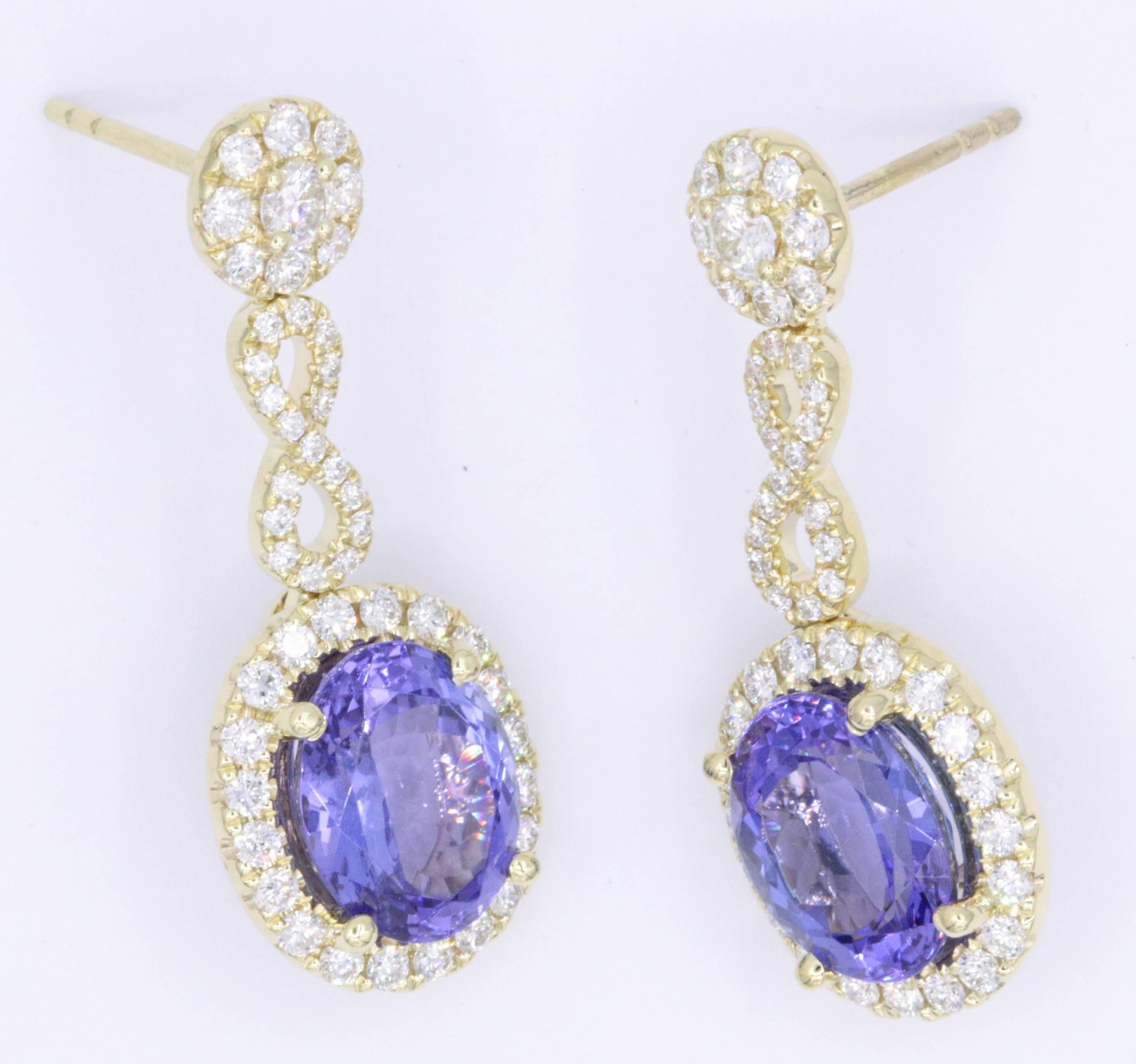 18K Yellow gold earrings featuring two oval shape Tanzanites measuring 7 x 9 mm each and weighing a total weight of 3.30 carats flanked with numerous weighing 1.13 carats. Color G-H Clarity SI
Earrings 1