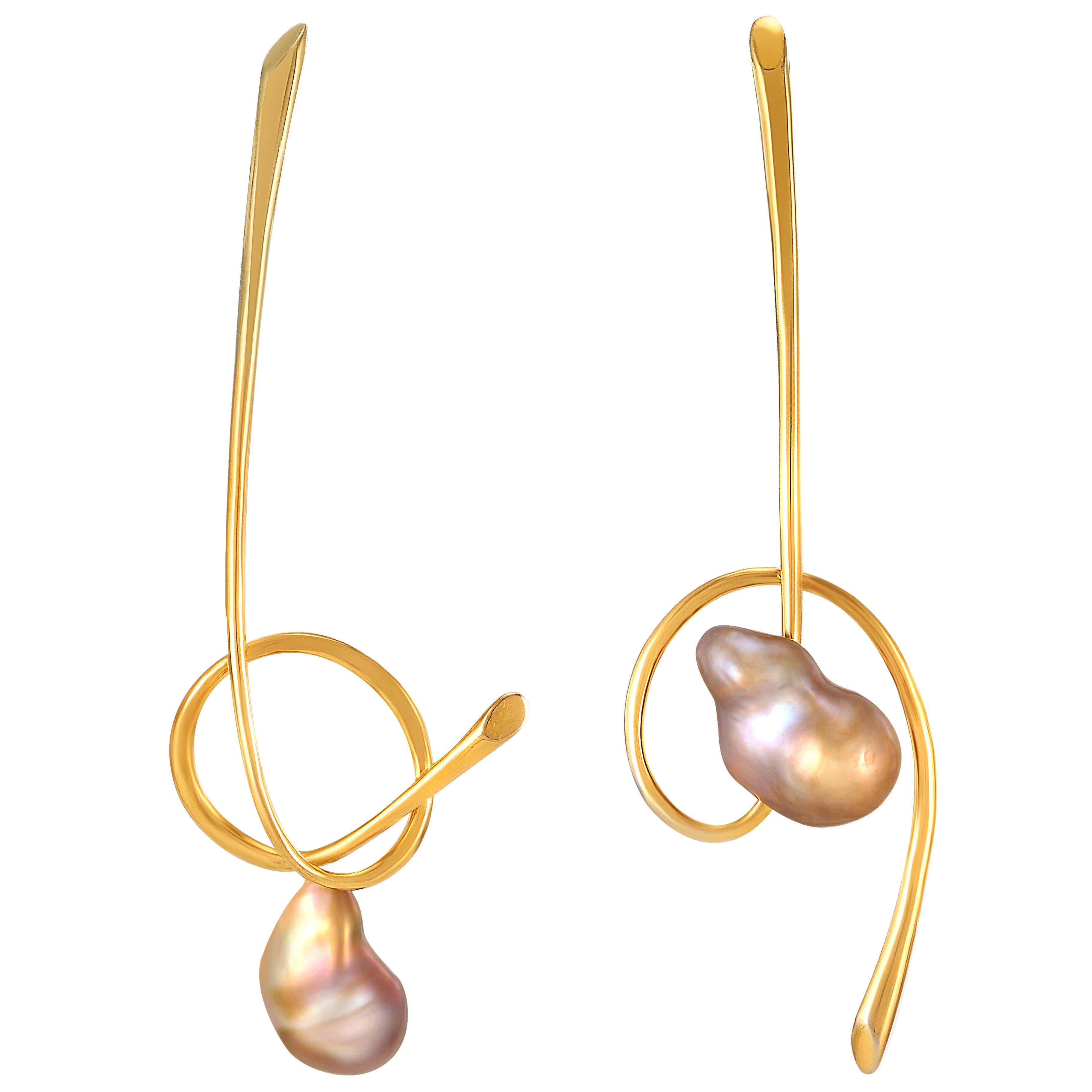 Baroque pearls set in these designed earrings feature dynamic curves with elegance hues. The endless value of this baroque pearl on the earrings she designed, showing an exceptional combination. Unbalance earrings with slightly different shapes on