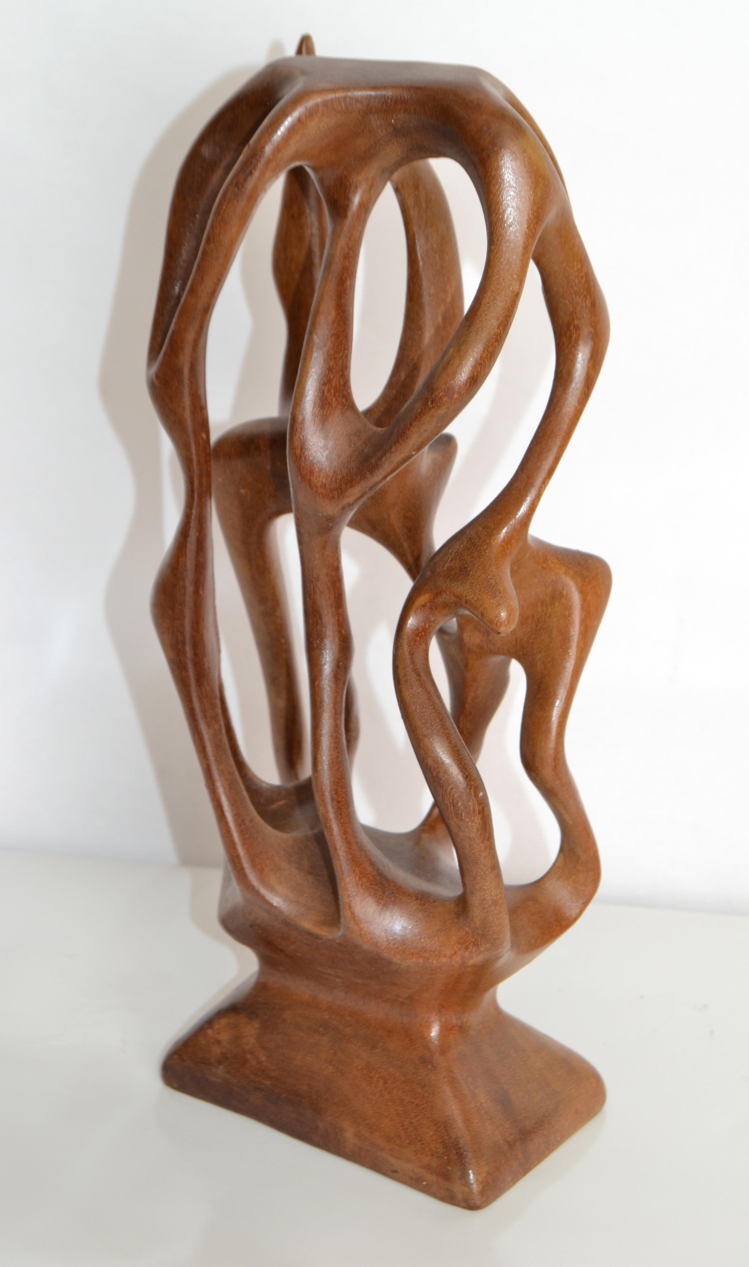 Charming free-form organic wooden sculpture is carved from one piece of Yew with its twisting curves colliding all angles. 
Yew trees are some of the oldest trees in the world. It is grown in many exotic shapes which determines the carving into a