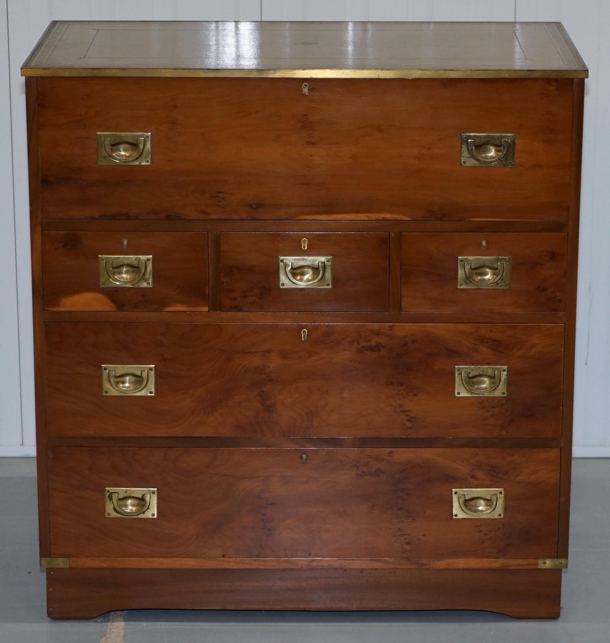 We are delighted to offer for sale this lovely yew wood Military Campaign chest of drawers with leather top and built-in desk bureau section

A very good looking and multifunctional piece, the top is full leather which I've never seen before, its
