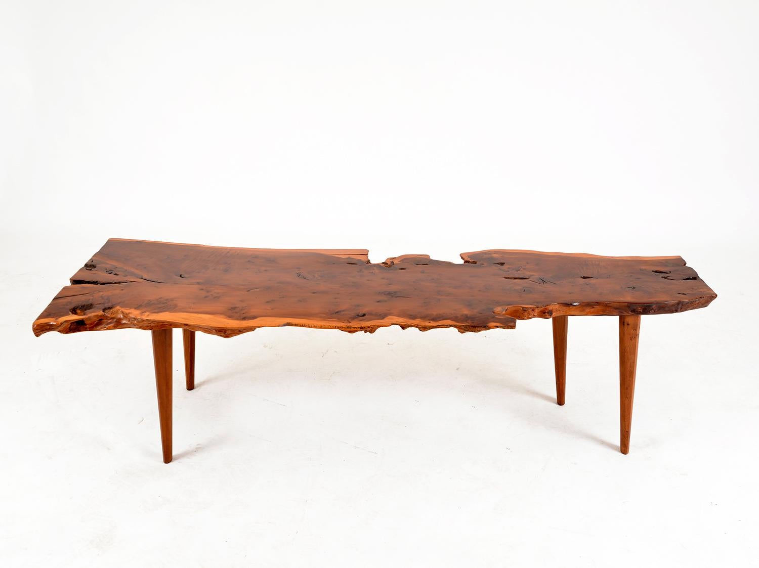 This large solid yew wood plank coffee was table made by the English makers Reynolds of Ludlow. This is a very stylish and solid piece, with a wonderful finish, rich figuring and a natural waney-edge. Much like the furniture of designer George