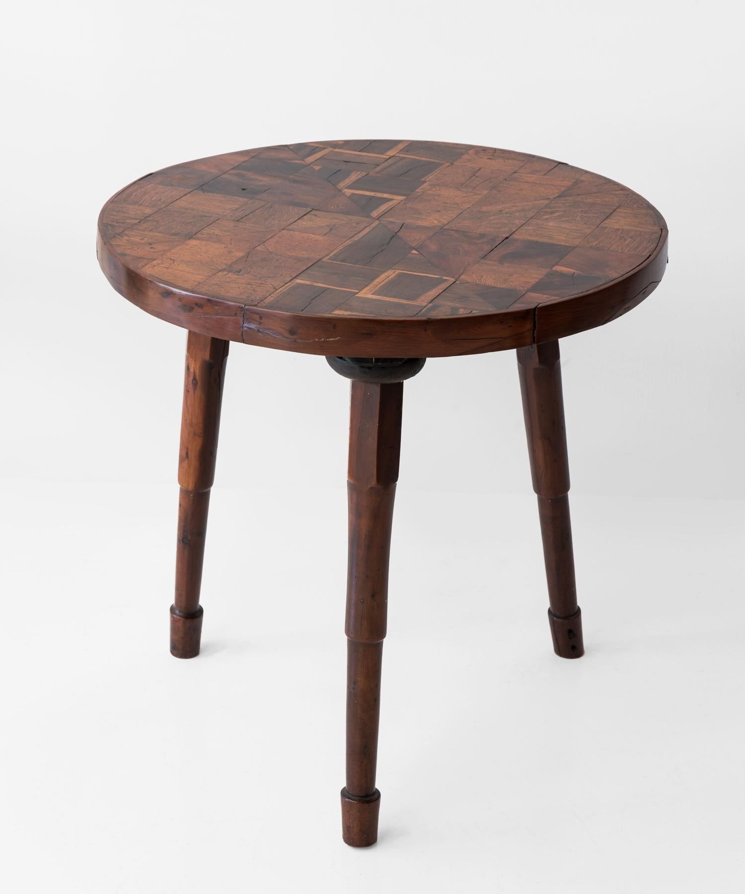 Circular top with radial parquetry in oak, laburnum and walnut on chamfered solid yew wood legs.
   