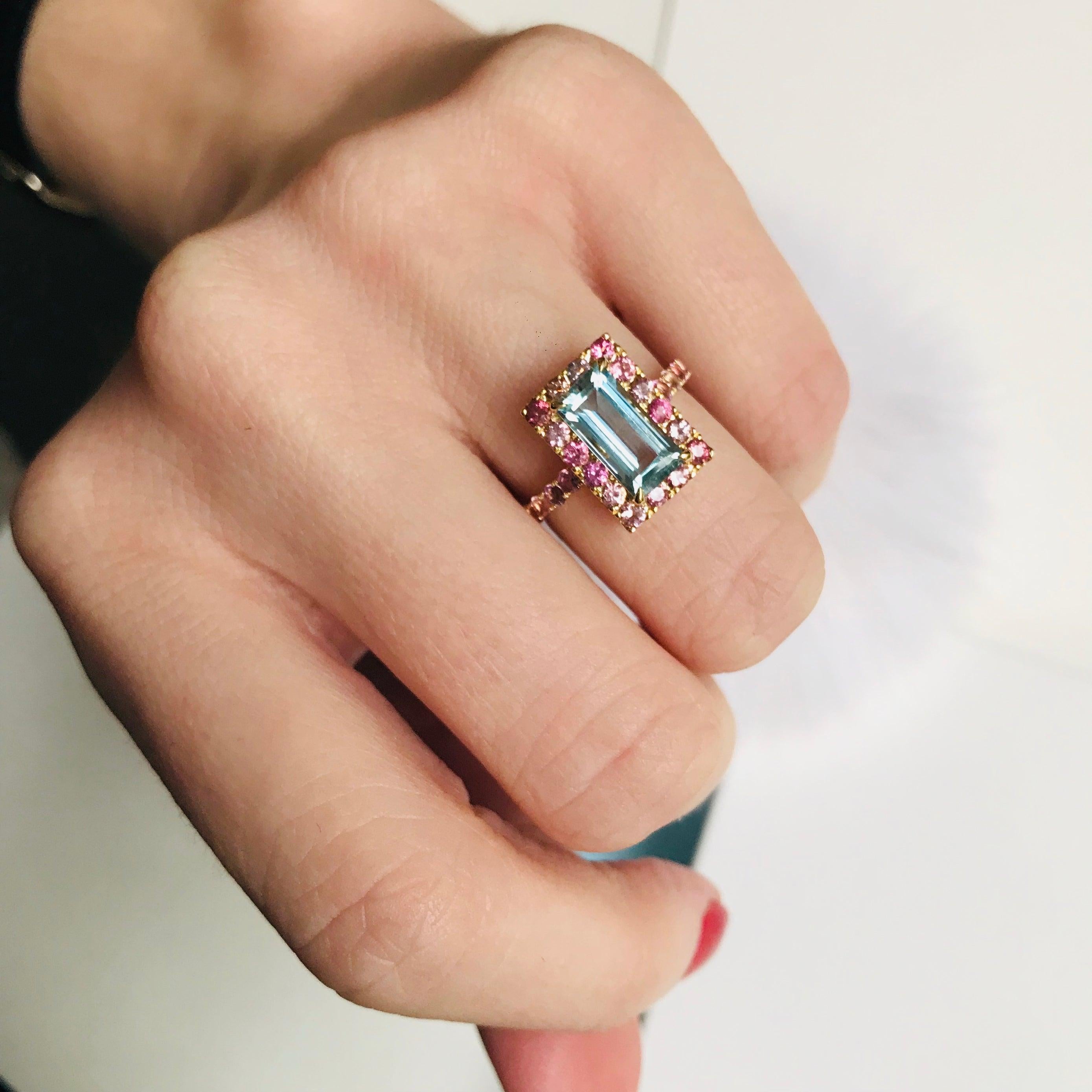 This youthful design showcases a gorgeous baguette aquamarine surrounded by an array of colorful pink tourmalines. . 

Our Aquamarine is as clear and blue as the cleans of the Maldives. A sprinkling of dazzling tourmalines in all shades of pinks
