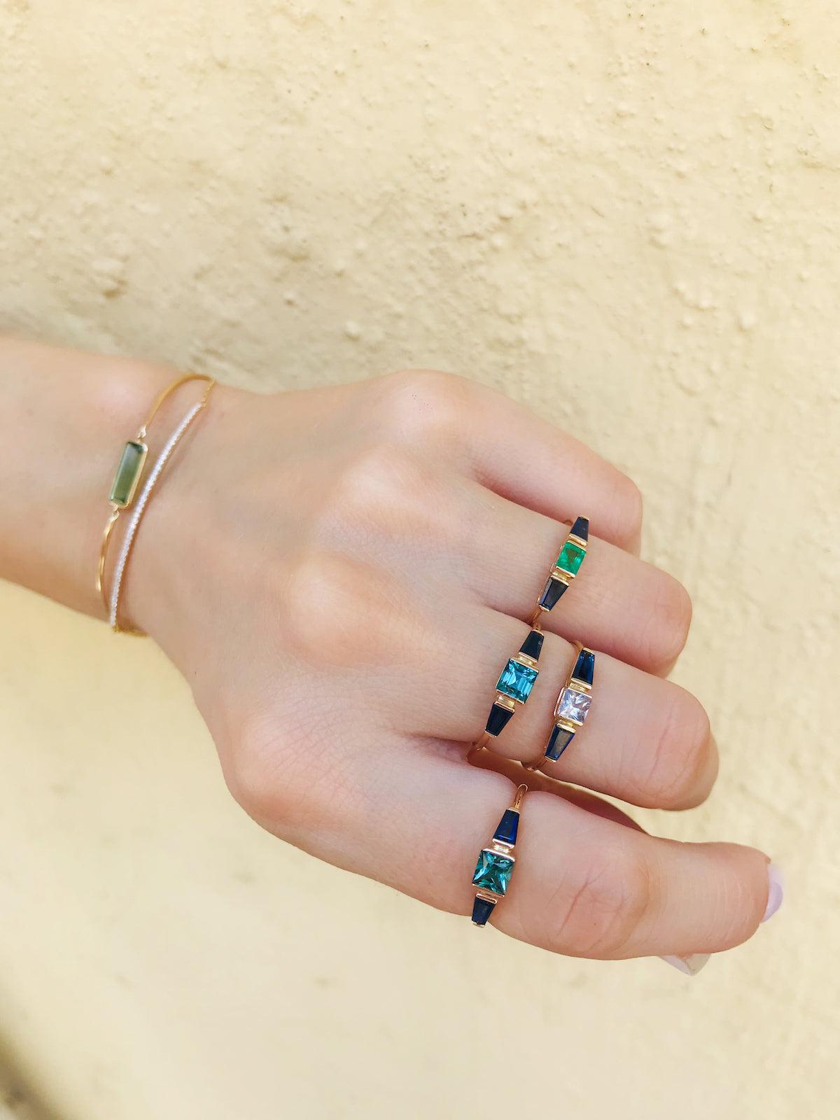 Our modern yet classic triplet rings are wonderfully hand forged with a central gemstone flanked by two gemstone shoulders.

It is a chic piece to pair with anything in your wardrobe. It stacks wonderfully with other rings from our collection or can