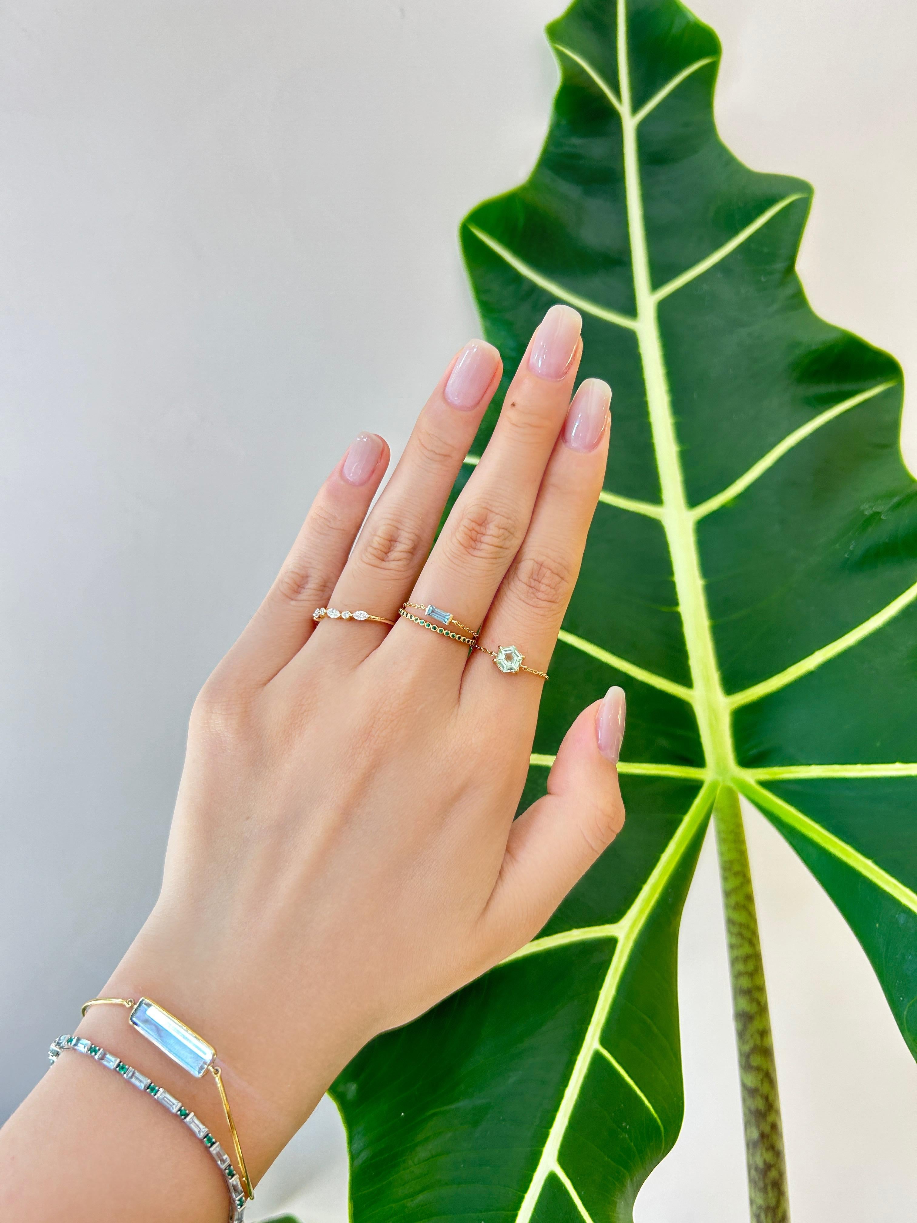A unique tourmaline cut made in-house. Our hexagon mint tourmaline is a sizable .80 carat gem radiating with light. Our chain rings are a signature creation. Each is mighty, with enough strength to withstand daily wear. We even wear ours to the gym.