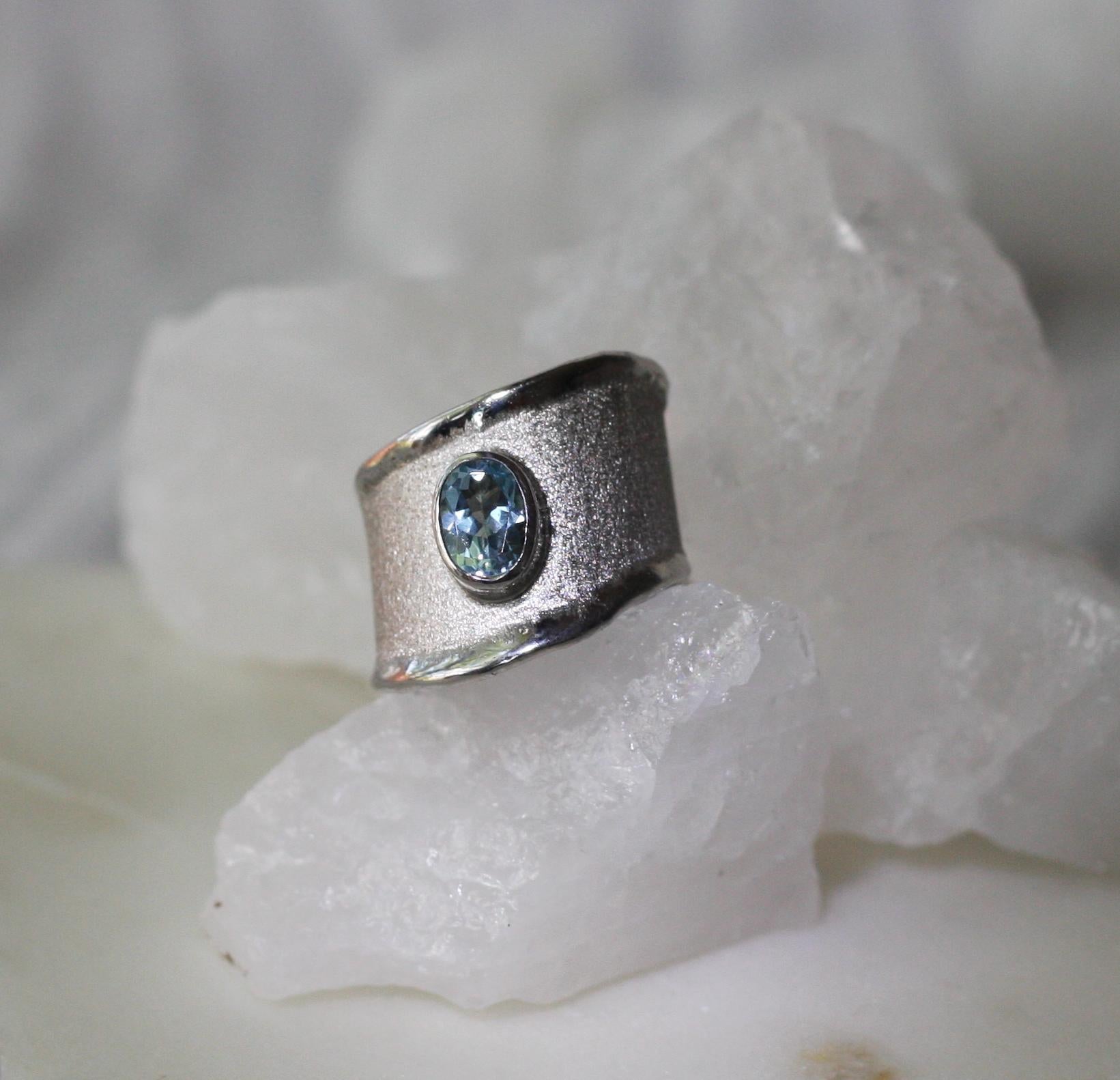 Presenting Yianni Creations fine silver artisan ring from Ammos Collection featuring 0.75 Carat oval cut aquamarine. The unique look of this simplified band is created by ancient techniques of craftsmanship - brushed texture and nature-inspired