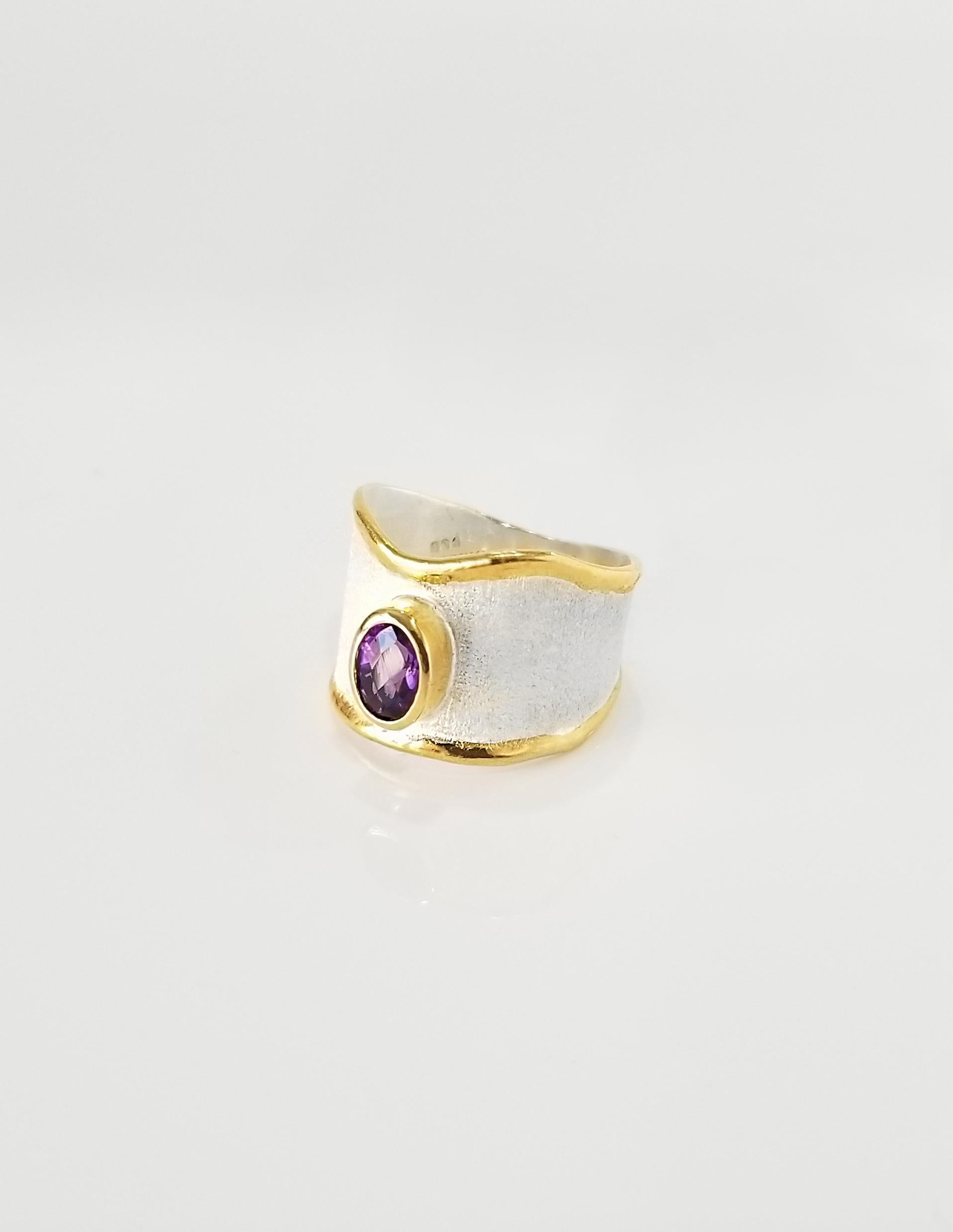 Yianni Creations Midas Collection 100% Handmade Artisan Ring from Fine Silver  950 purity plated with Palladium to resist the Elements. Liquid edges are decorated with a layover of 24 Karat Yellow Gold. The ring features 0.85 Carat Oval Shape