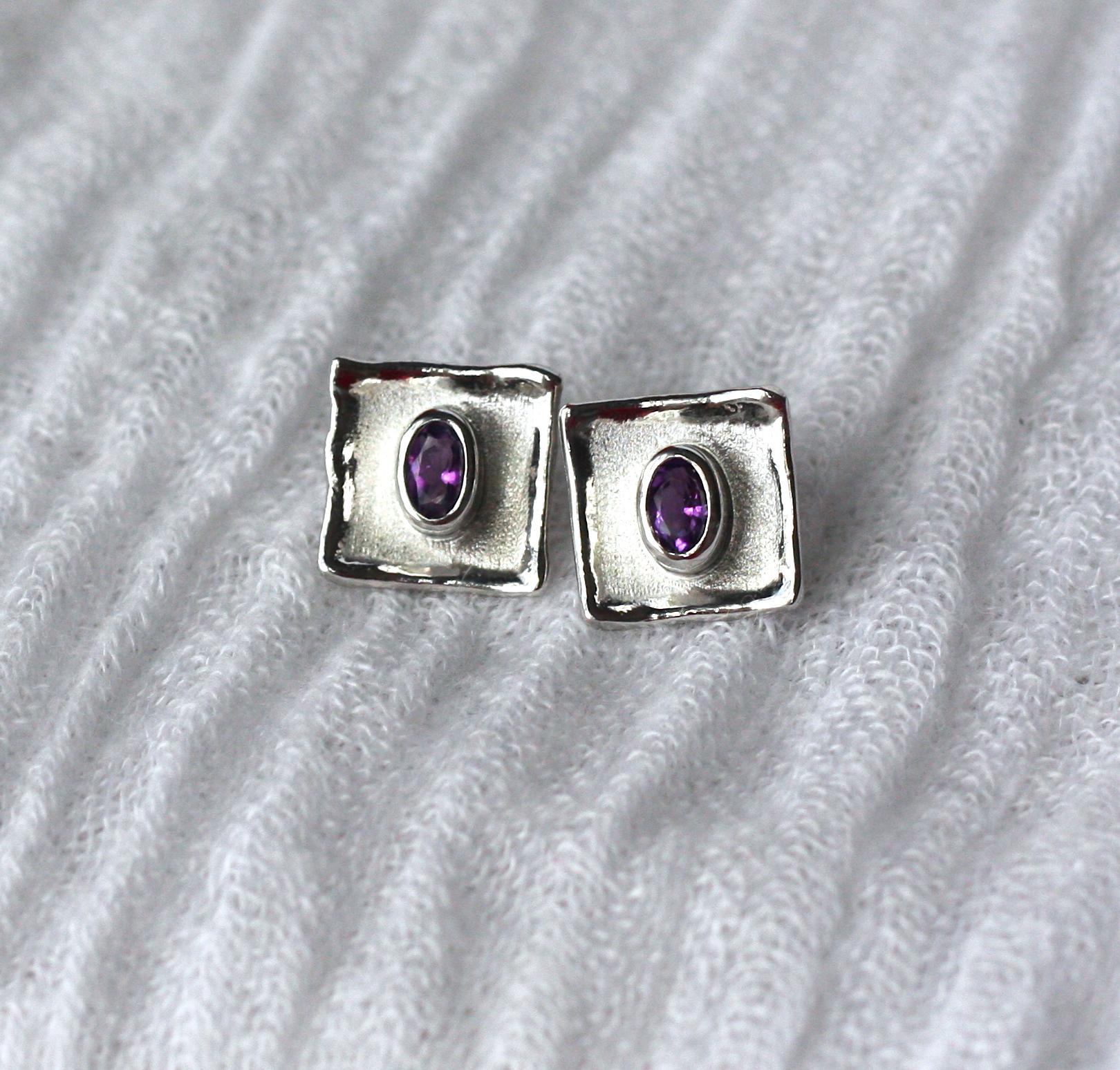 These fine silver and palladium plated Yianni Creations stud earrings from Ammos Collection are all handmade in Greece in our workshop. They are smaller size studs with a big effect. The square shape complements the 0.45 Carat oval Amethysts and