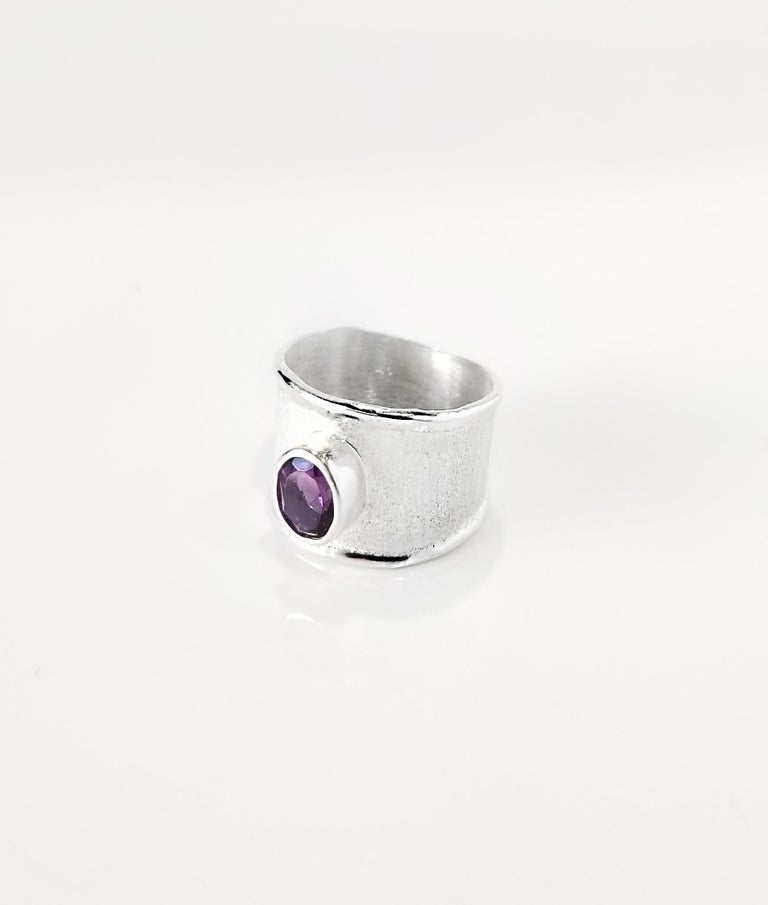Yianni Creations Ammos Collection 100% Handmade Artisan Ring from Fine Silver featuring 1.25 Carat Amethyst complemented by unique techniques of craftsmanship - brushed texture and nature-inspired liquid edges. The core of this beautiful ring is
