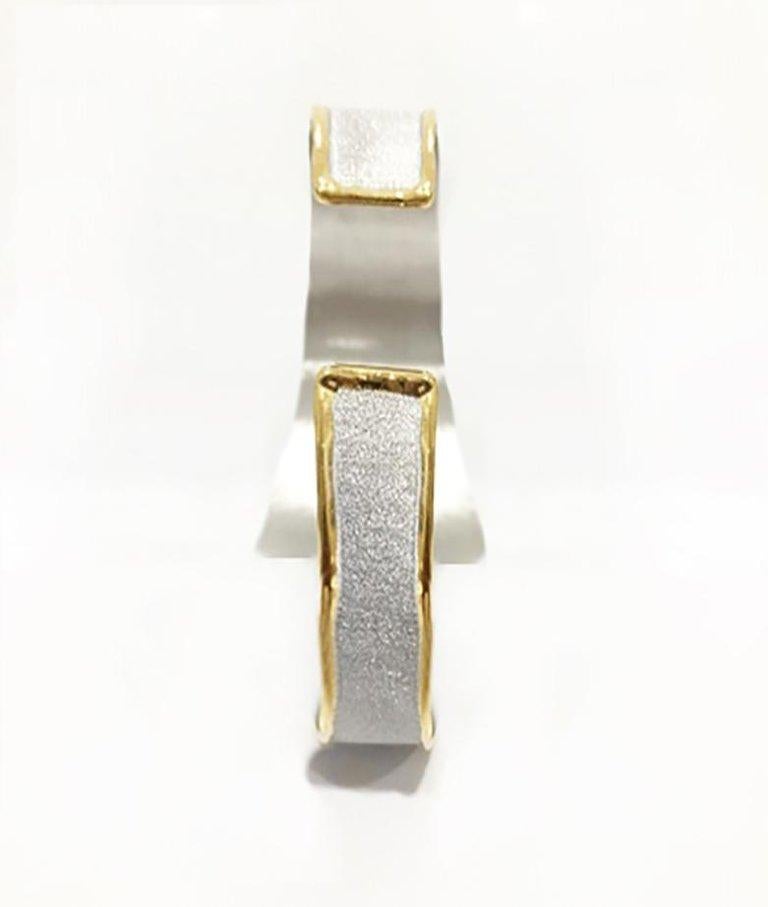 Yianni Creations is presenting geometry inspired bracelet from Midas Collection. It is a 100% handmade artisan jewel crafted from fine silver 950 purity plated with palladium to protect it from the elements. The liquid edge is decorated by 24 Karat