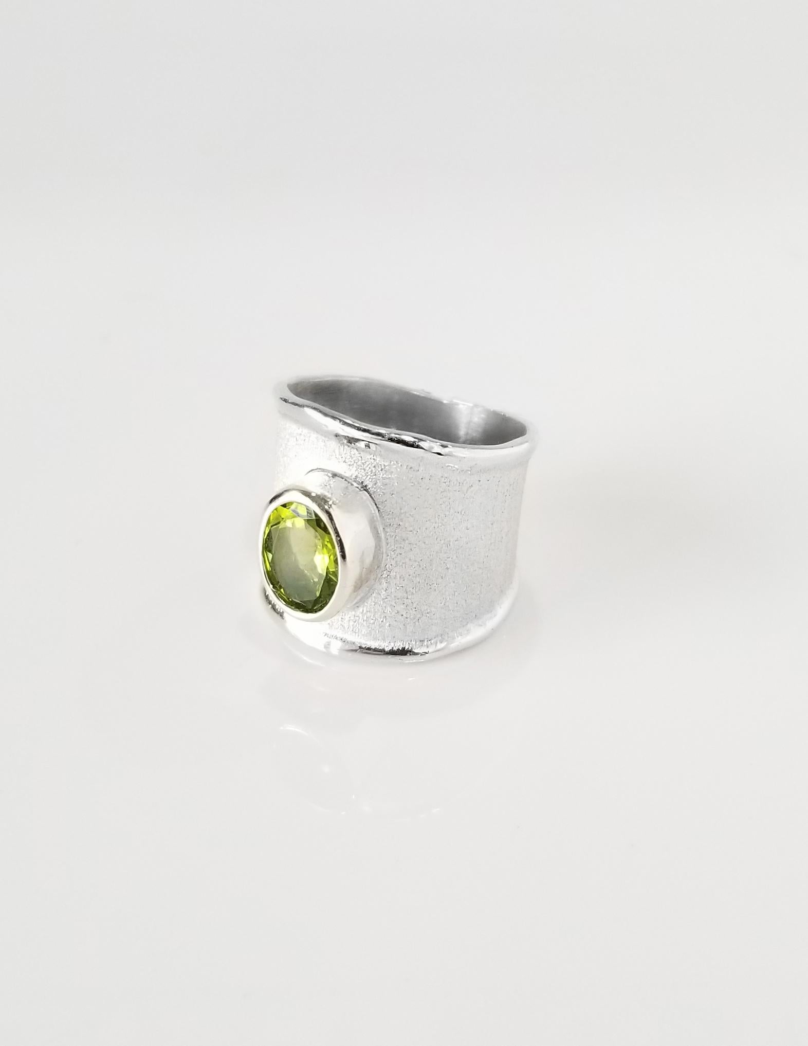 Yianni Creations Ammos Collection 100% Handmade Artisan Ring from Fine Silver featuring 1.35 Carat Peridot complemented by unique techniques of craftsmanship - brushed texture and nature-inspired liquid edges. The core of this beautiful