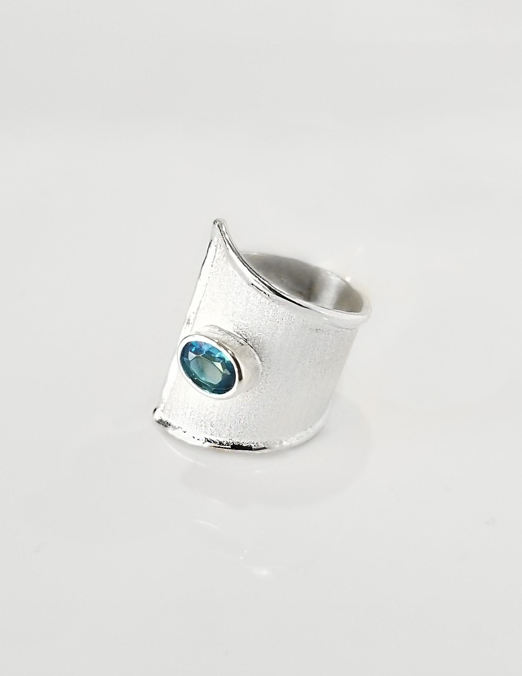 Artisan ring Yianni Creations from Ammos Collection handcrafted in Greece from fine silver 950 purity and plated with palladium to protect it from the tarnish. This adjustable ring is featuring 1.60 Carat Oval Cut London Blue Topaz complemented by