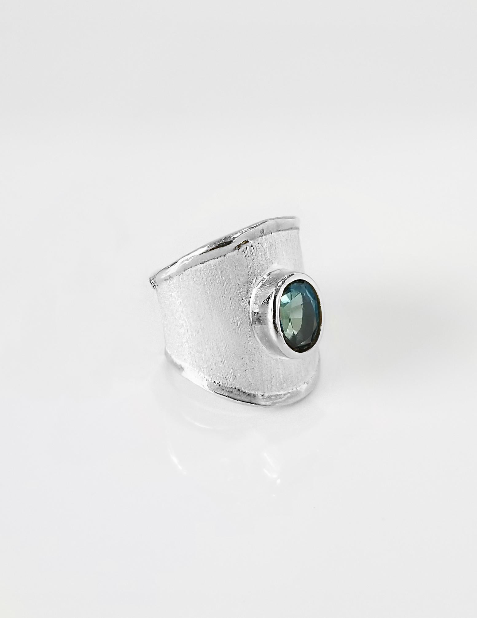 From Yianni Creations - Ammos Collection this is a 950 purity fine silver ring handmade in Greece with brushed texture plated with palladium to resist the elements. The unique look is completed by 1.60 Carat oval cut London blue topaz. Contact us