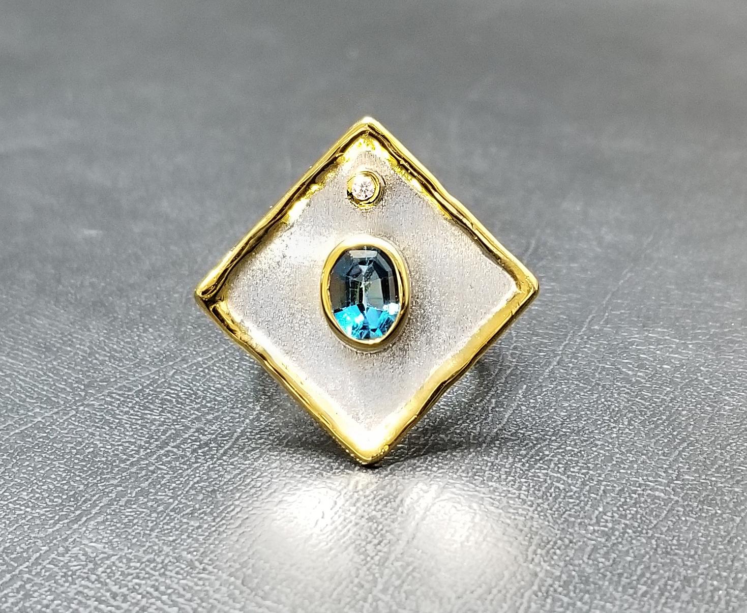 Presenting Yianni Creations - Ammos Collection fully handcrafted ring from Fine Silver plated with Palladium to resist the elements. This geometric-shaped ring features 1.60 Carat London Blue Topaz accompanied by 0.03 Carat Brilliant Cut White