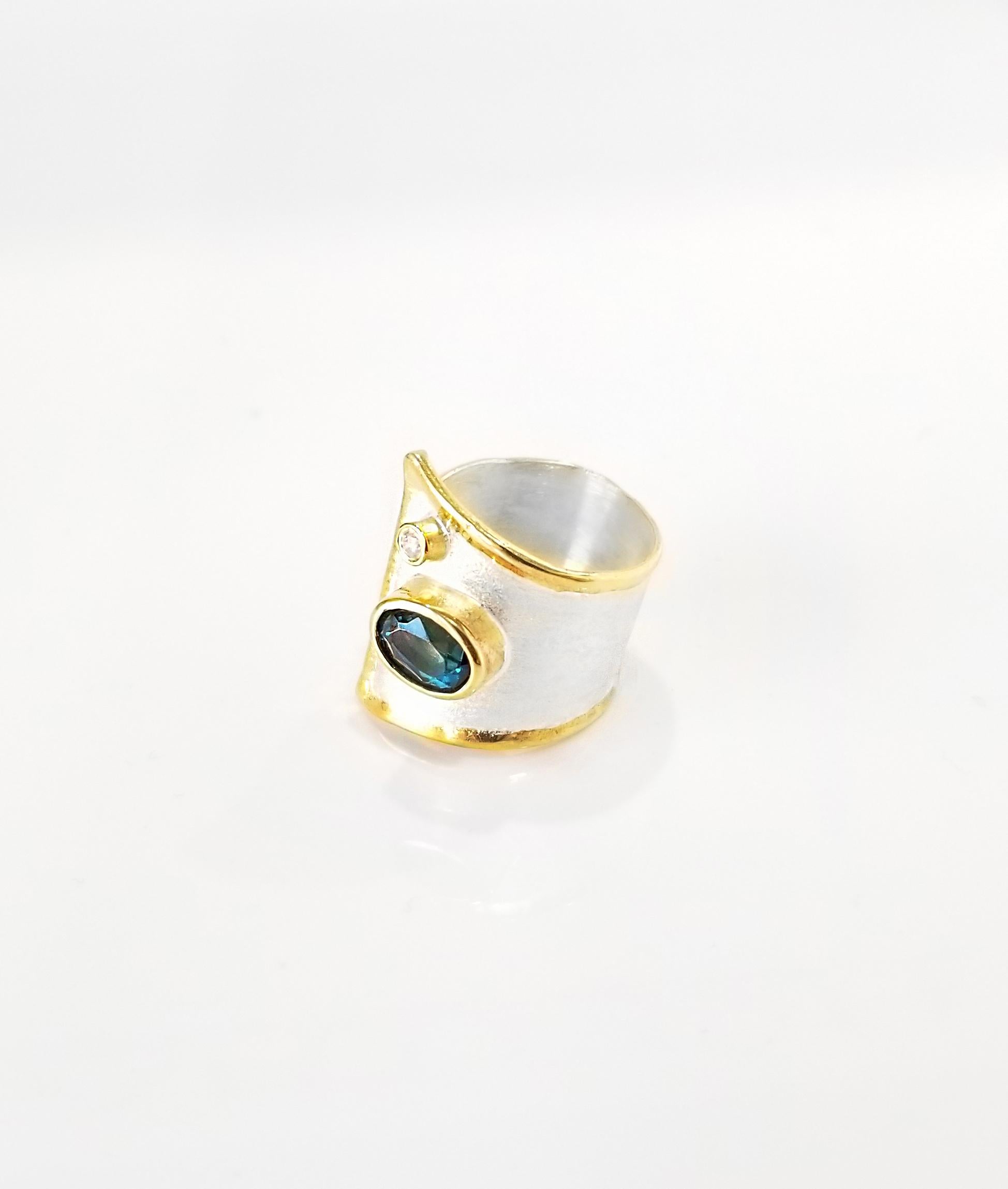 Yianni Creations Midas Collection 100% Handmade Artisan Gorgeous Ring from Fine Silver with an overlay of 24 Karat Yellow Gold features 1.60 Carat London Blue Topaz accompanied by 0.03 Carat Diamond complemented by unique techniques of craftsmanship