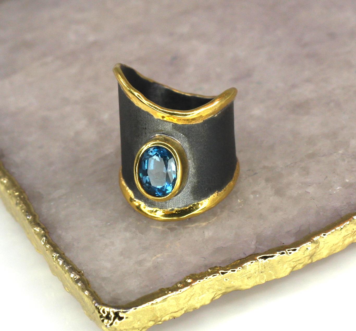 Introducing Yianni Creations Eclyps Collection handmade artisan ring from fine silver 950 purity. The brushed surface is plated with Black Rhodium and the liquid edges decorated with a thick overlay of 24 Karat yellow gold. The ring features a 1.60