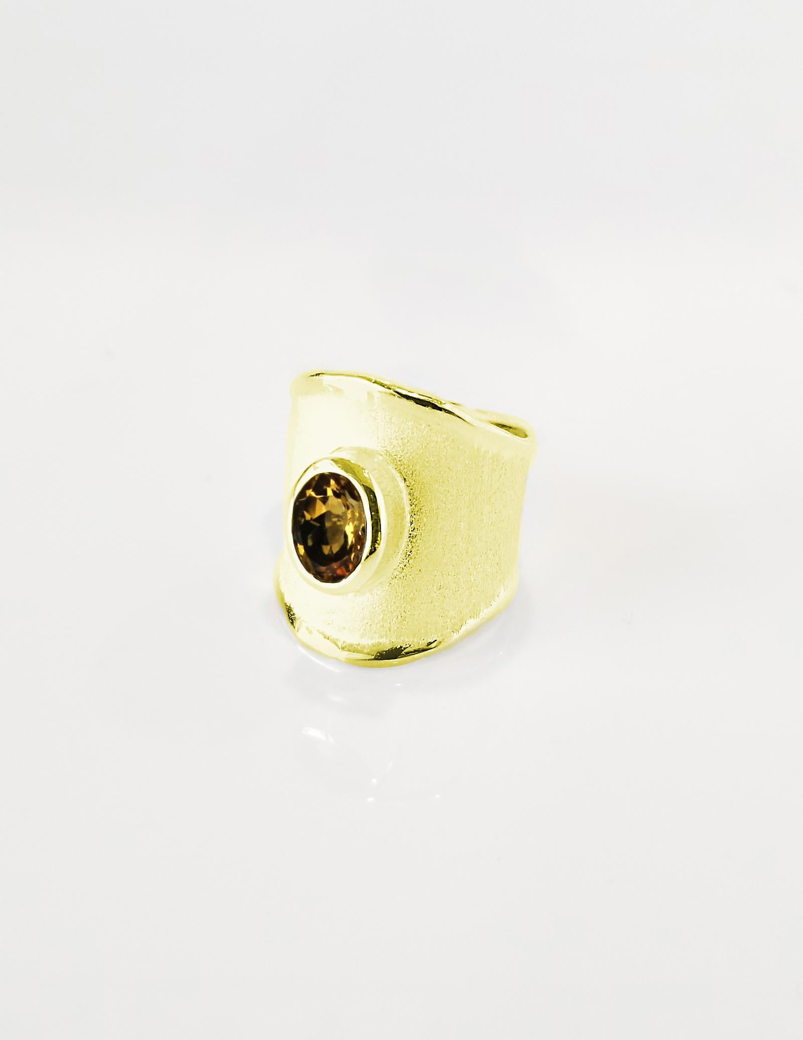 Presenting Yianni Creations ring all handcrafted in Greece from 18 Karat yellow gold. This gorgeous wide band ring features a 1.25 Carat oval cut Citrine and ancient techniques of workmanship that create a unique look. The beautiful design is also