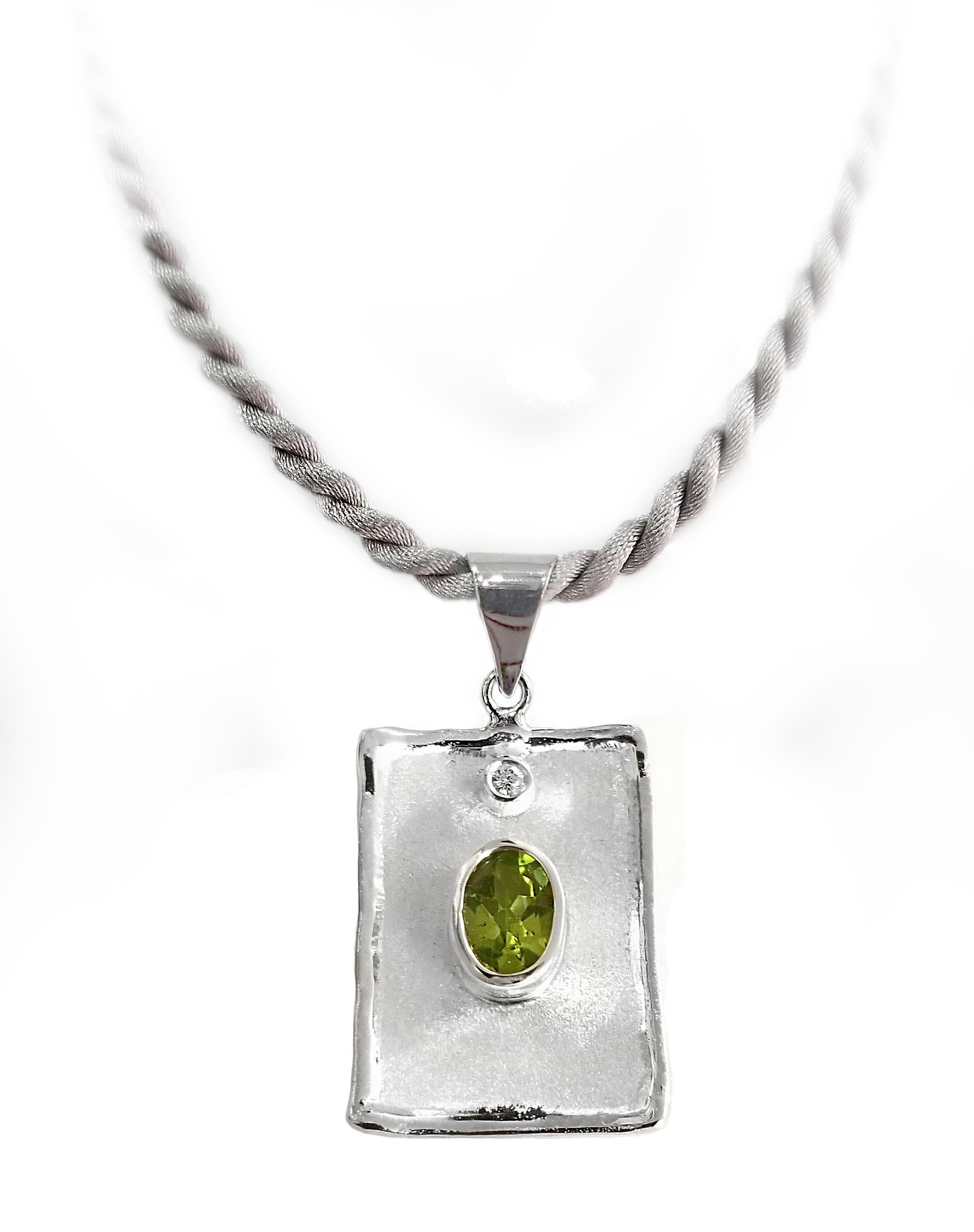 Yianni Creations Ammos Collection 100% Handmade Artisan Pendant from Fine Silver featuring 2 Carat Oval Cut Peridot accompanied by 0.03 Carat Brilliant Cut White Diamond complemented by unique techniques of craftsmanship - brushed texture and
