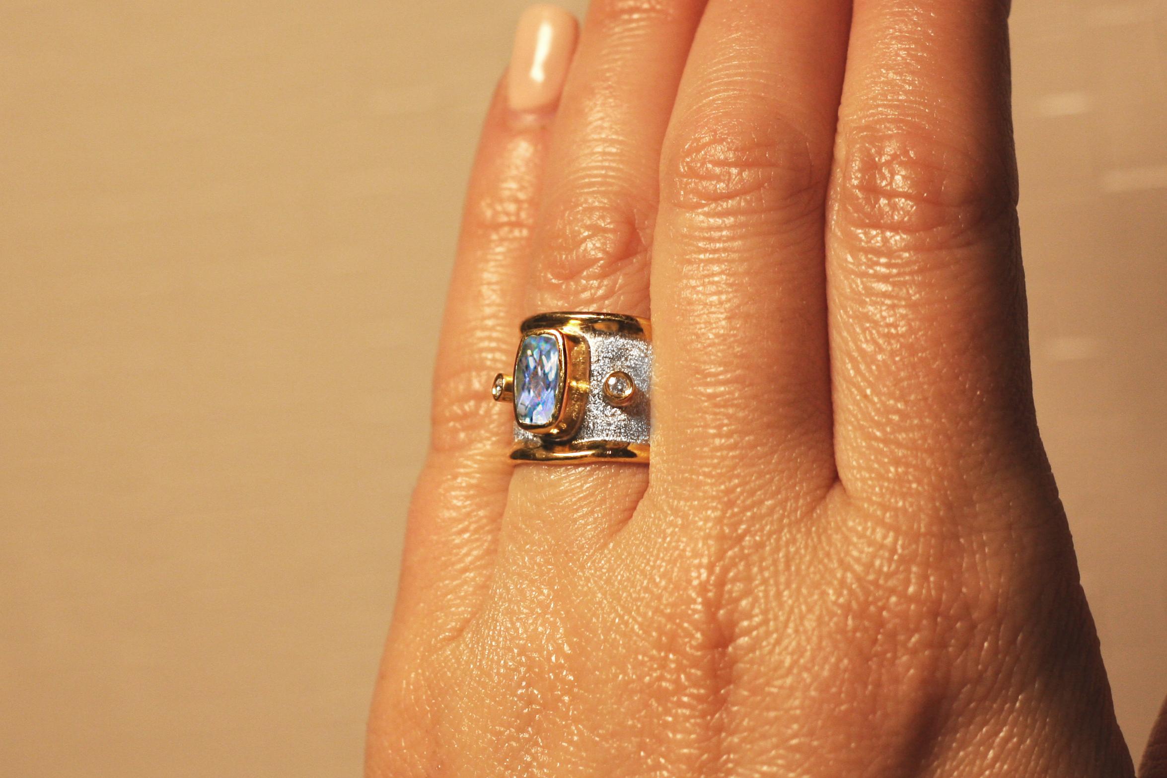 Don't let go this one of a kind Yianni Creations ring with rectangular shaped 2.20 Carat Aquamarine complemented by two brilliant cut diamonds of total weight 0.06 Carat. Yianni, the designer loves stones and when he comes across some special stone,