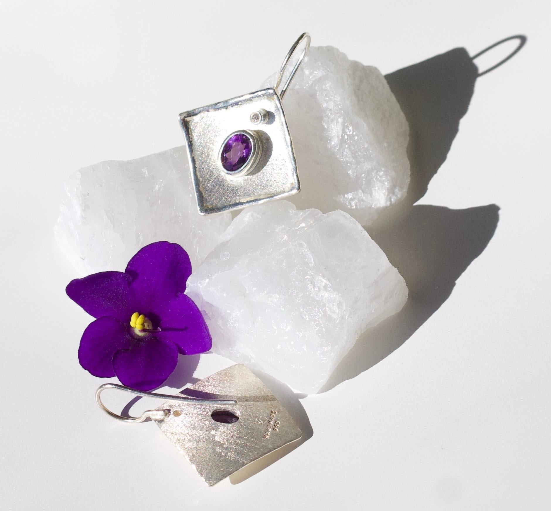 From Yianni Creations Ammos Collection, this is handmade artisan earrings from Fine Silver plated with palladium to resist against elements. Each earring feature 1.25 Carat oval cut Amethyst complimented by 0.03 Carat Brilliant cut Diamond. These