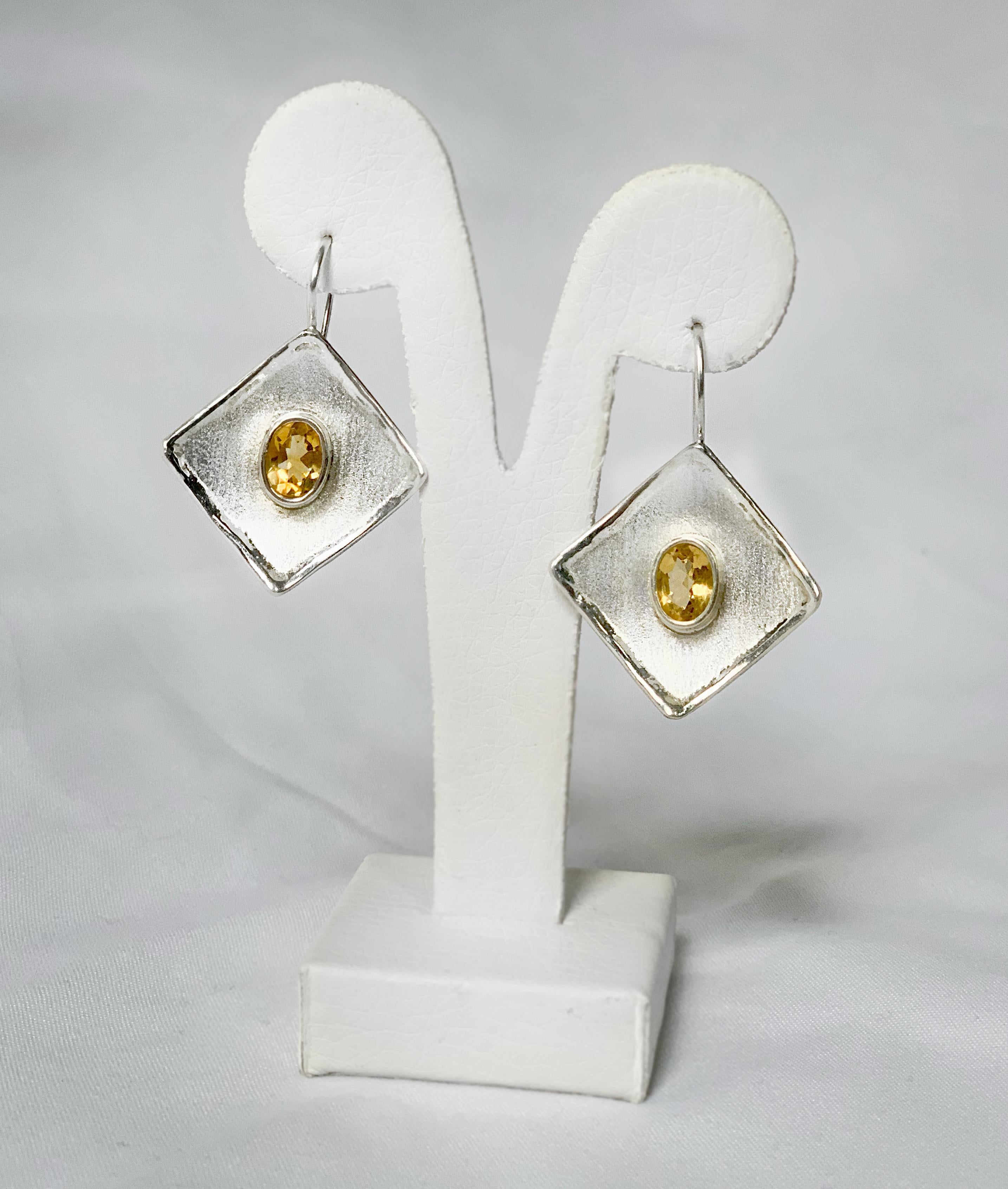 Yianni Creations Ammos Collection 100% Handmade Artisan Earrings from Fine Silver plated with palladium to protect the jewels from the Elements. Each earring feature a 1.25 Carat Oval Cut Citrine. Brushed texture and nature-inspired liquid edges