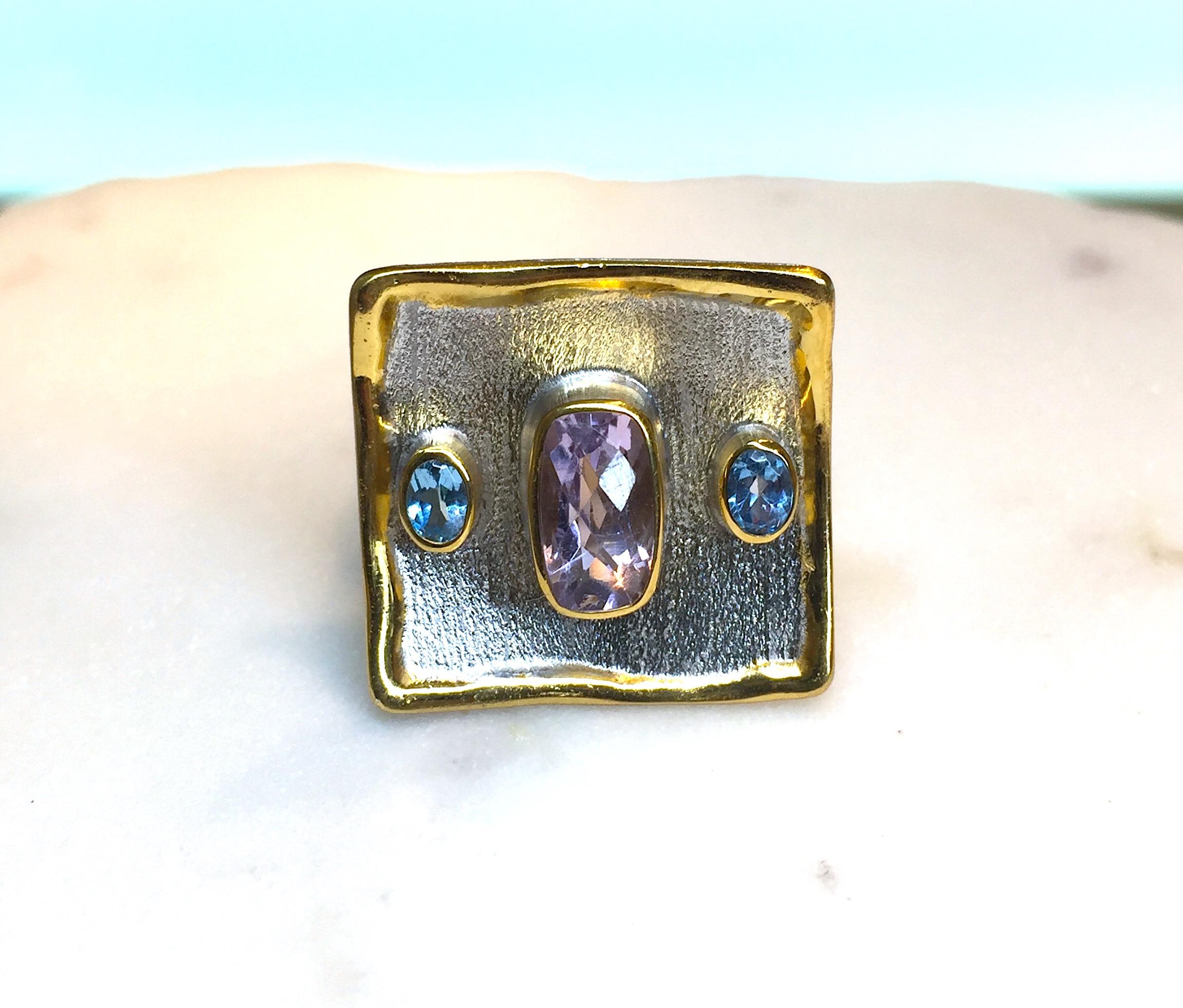 Yianni Creations is 100% handmade from fine silver 950 purity and plated with palladium to resist against elements and all custom-made. This stunning geometric-shaped ring features 1.60 Carat Amethyst and on the sides 2 Blue Topaz total weight 1.20