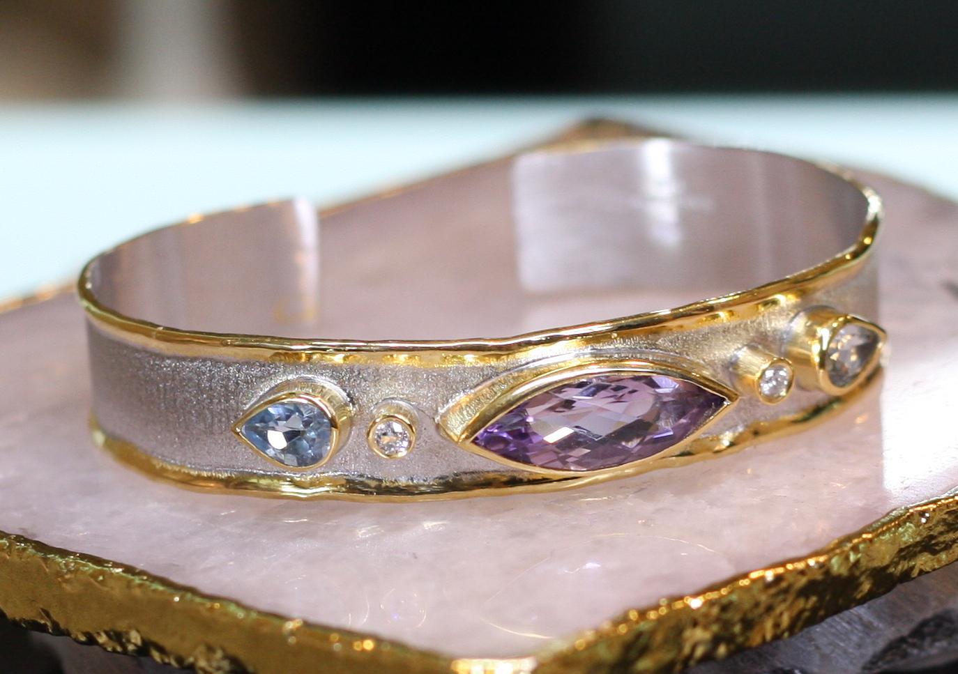 Yianni Creations all handmade in Greece from fine silver 950 purity and plated with palladium to resist the elements and all custom-made.  This gorgeous bracelet is a total weight of 5.70 Carat Amethyst in marquise shape, 2 Blue Topaz in pear shape