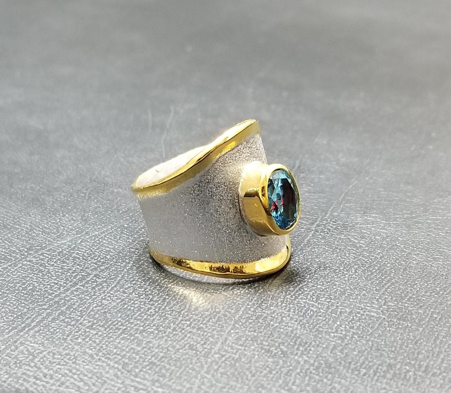 From Yianni Creations - Midas Collection is a 950 purity fine silver and 24 karat gold band ring handmade in Greece. The gorgeous ring is plated with palladium to resist the elements and the liquid edges are decorated with 24-carat gold. The unique