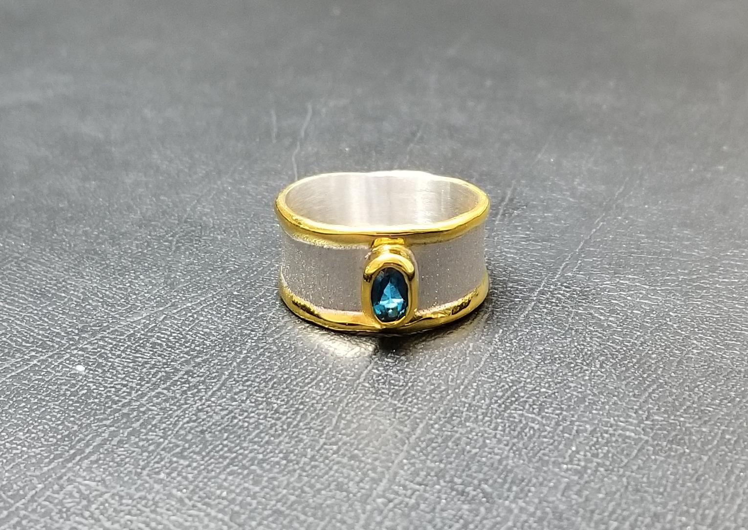 Oval Cut Yianni Creations Blue Topaz Band Ring in Fine Silver and 24 Karat Yellow Gold