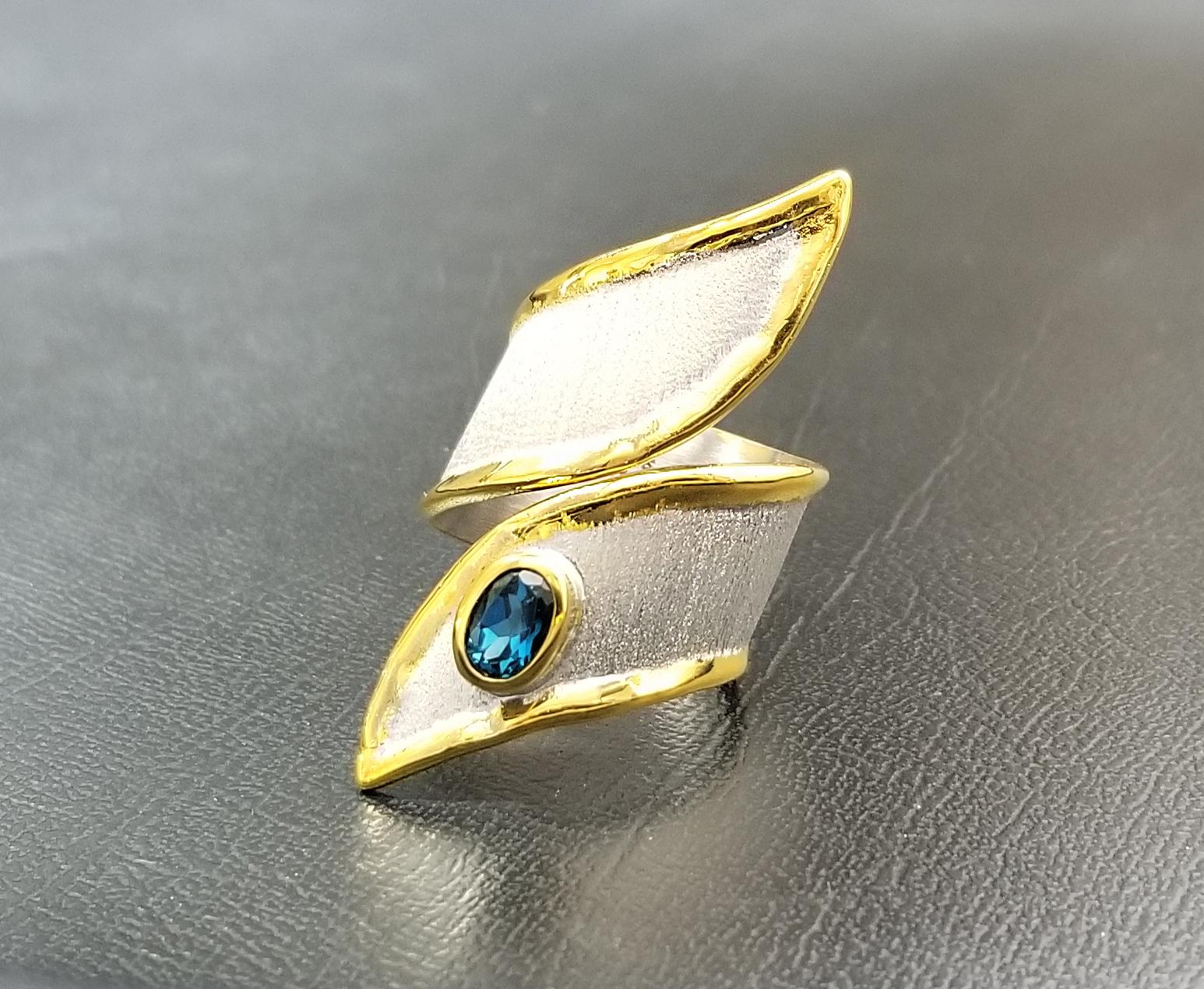 Yianni Creations wide handmade artisan ring from Midas Collection crafted from fine silver 950 purity plated with palladium to resist the elements. Liquid edges are decorated with a thick layer of 24 Karat yellow gold. This gorgeous asymmetric ring