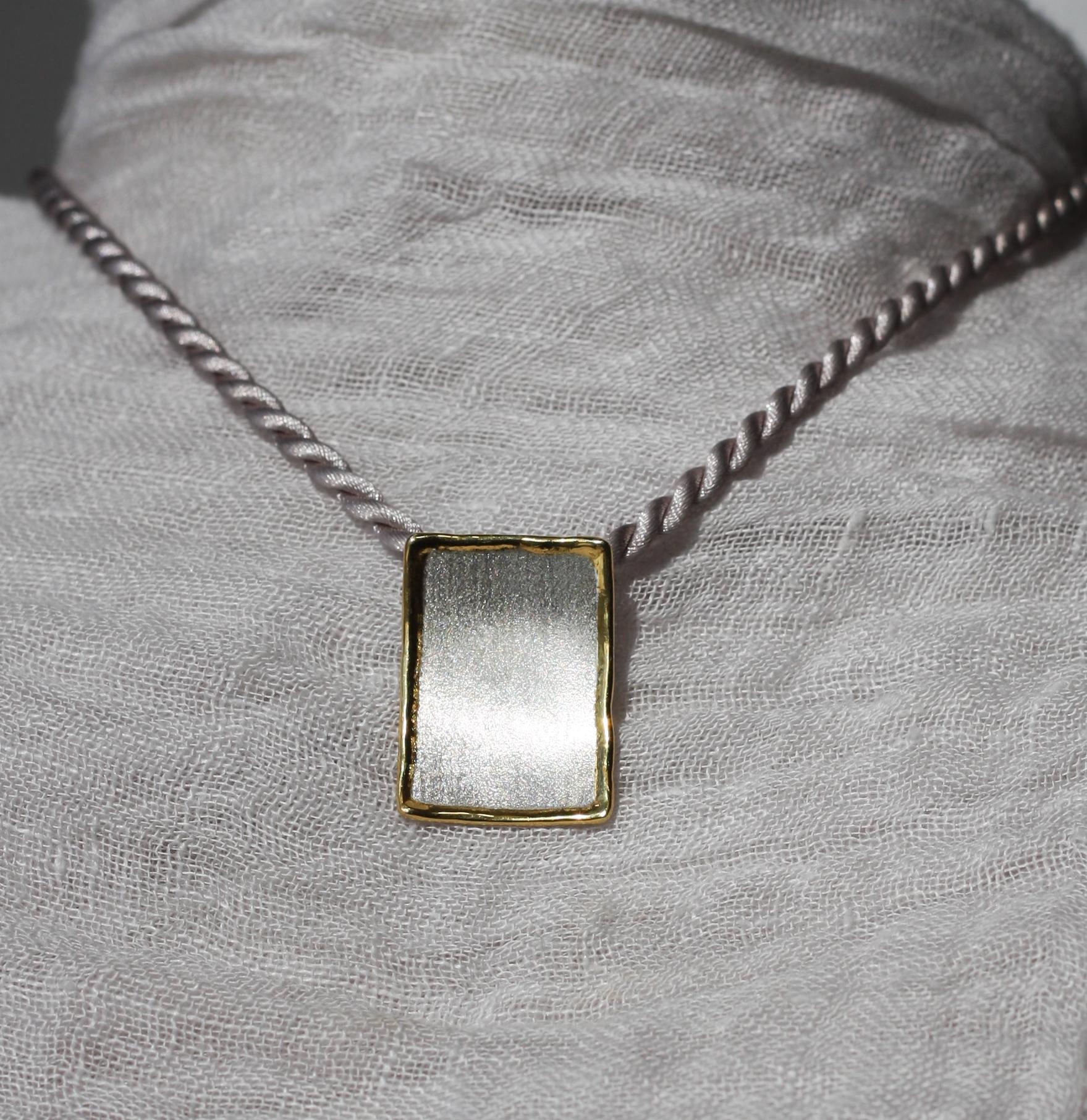 We are presenting Yianni Creations geometrically shaped pendant enhancer from Midas Collection, which is all handcrafted from fine silver 950 purity and plated with palladium to resist the elements. This rectangular artisan pendant in its purity