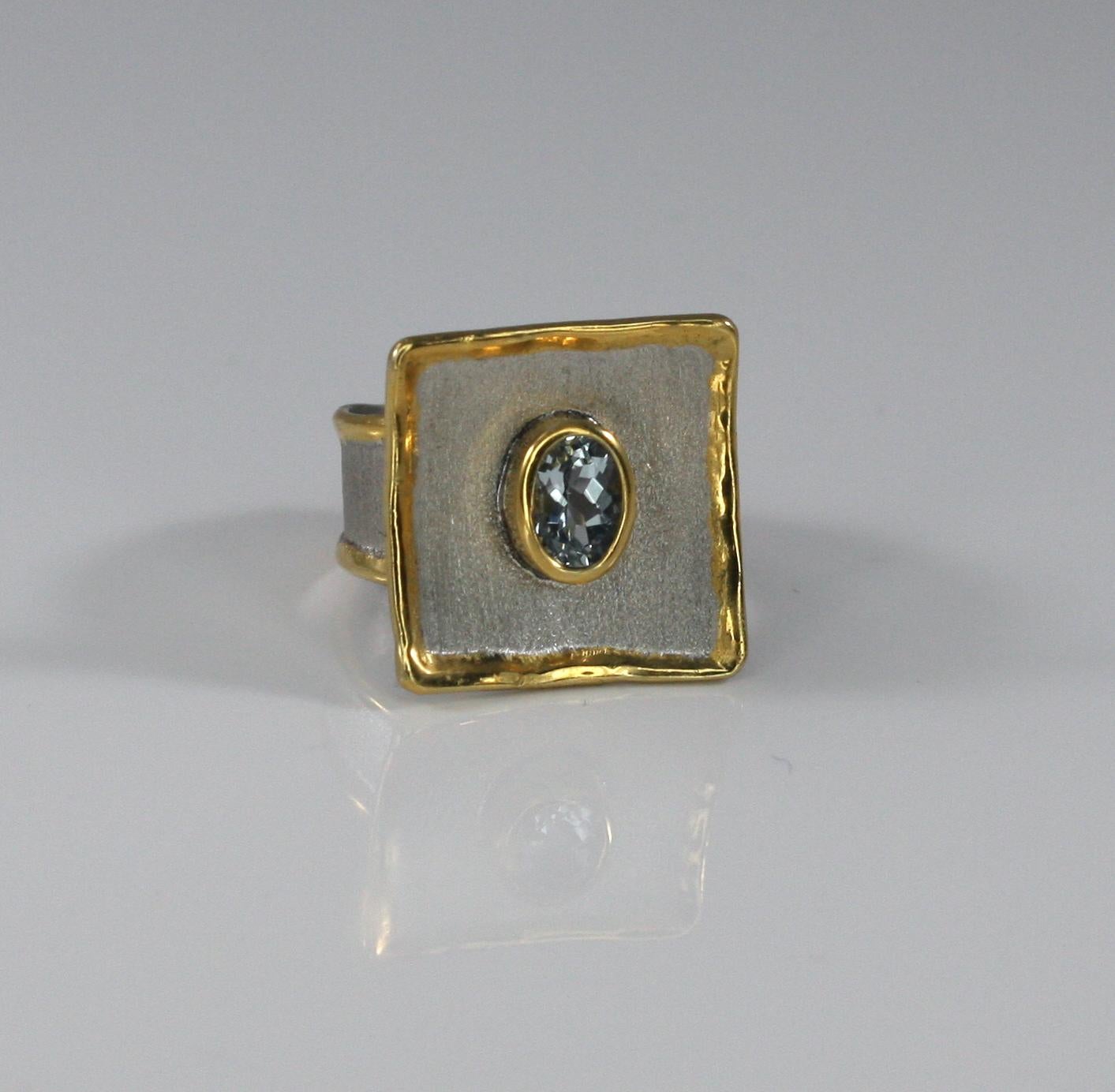 Yianni Creations handmade artisan ring is made from fine silver 950 purity plated with palladium to resist the elements. This square ring from Midas Collection has edges decorated with 24 Karat gold thick overlay and features 1.10 Carat Oval